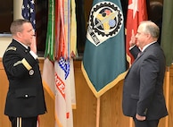 Maj. Gen. Steven Shapiro, commanding general, U.S. Army Sustainment Command, reads the oath of office, swearing Dan Reilly in to the Senior Executive Service at Rock Island Arsenal, IIlinois, June 4.