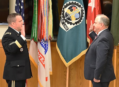 Maj. Gen. Steven Shapiro, commanding general, U.S. Army Sustainment Command, reads the oath of office, swearing Dan Reilly in to the Senior Executive Service at Rock Island Arsenal, IIlinois, June 4.