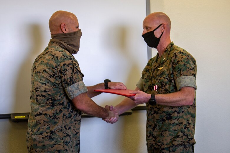 U.S. Marine Corps Lt. Col. Henry Hortenstine, an operations officer, was awarded the Meritorious Service Medal by Col. David A. Suggs, commanding officer, Marine Corps Air Station (MCAS) Yuma at the base operations building, June 4, 2020. During Sentinel Edge 2019, Hortenstine led the largest exercise in Marine Corps history, moving troops and equipment in an effort to build new roads and integrate Marine Forces Reserve with active-duty Marines. (U.S. Marine Corps photo by LCpl Gabrielle Sanders)