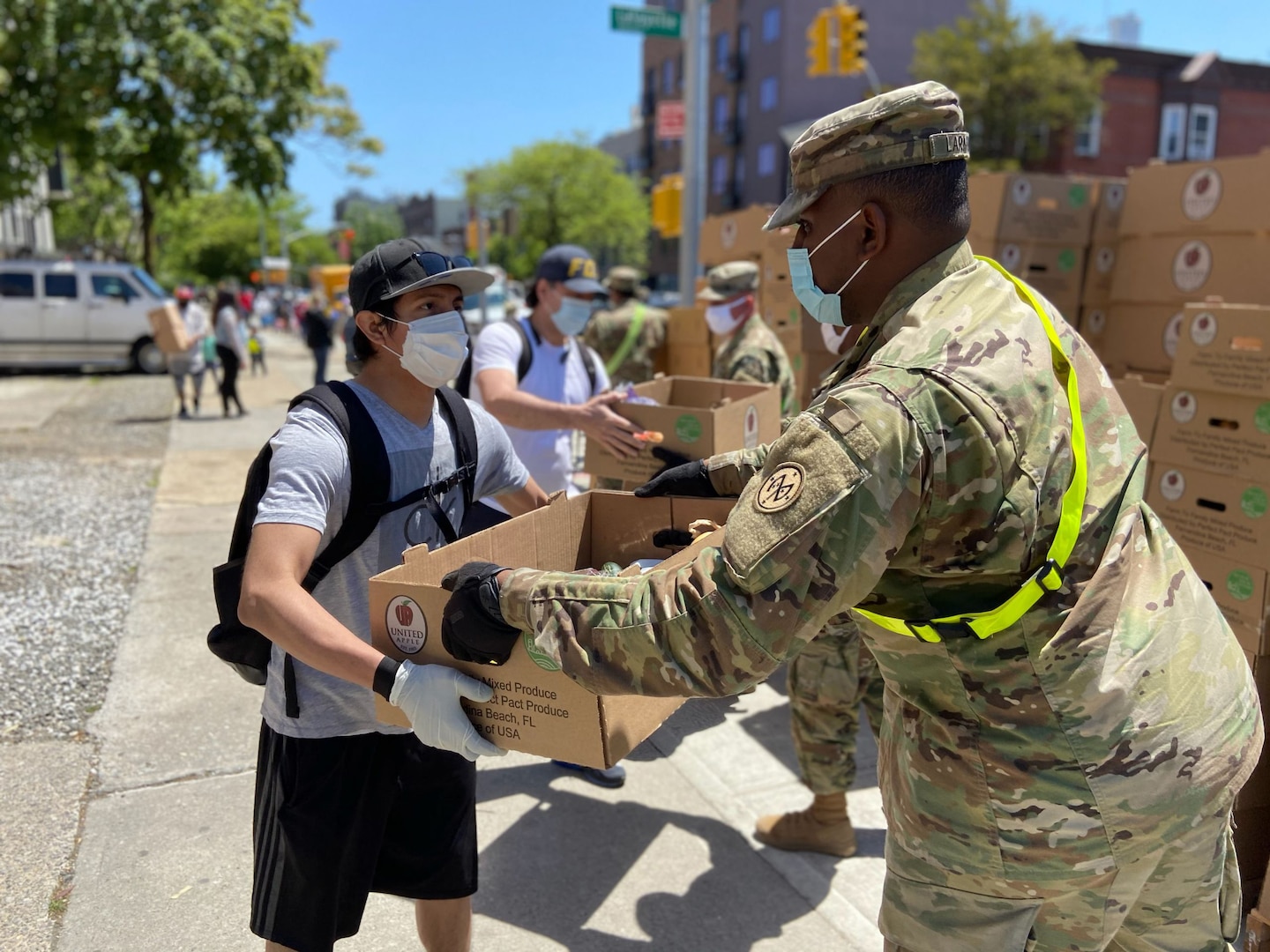 U.S. Army Pfc. Kristoffshakur Larmond, assigned to the 1st Battalion, 258th Field Artillery, part of the 27th Infantry Brigade Combat Team, distributes produce and canned goods in the Bushwick neighborhood of Brooklyn, N.Y., May 27, 2020. Troops have helped deliver more than 16 million meals to New Yorkers during the COVID-19 pandemic.