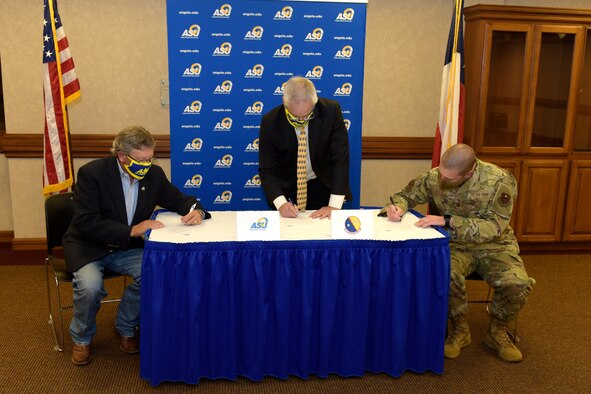 The Provost and Vice President of Academic Affairs of Angelo State University Donald Topliff; the Dean of Science and Engineering of ASU Paul Swets, and U.S. Air Force Major David Coté, 17th Communication Squadron commander, sign an agreement providing Airmen a new opportunity to earn a bachelor’s degree, at ASU’s Houston Harte University Center, in San Angelo, Texas, June 15, 2020. With this new agreement, individuals will be able to receive credit for all of their academic coursework, as well as credit for up to 60 credit hours of technical course work. (U.S. Air Force photo by Senior Airman Zachary Chapman)