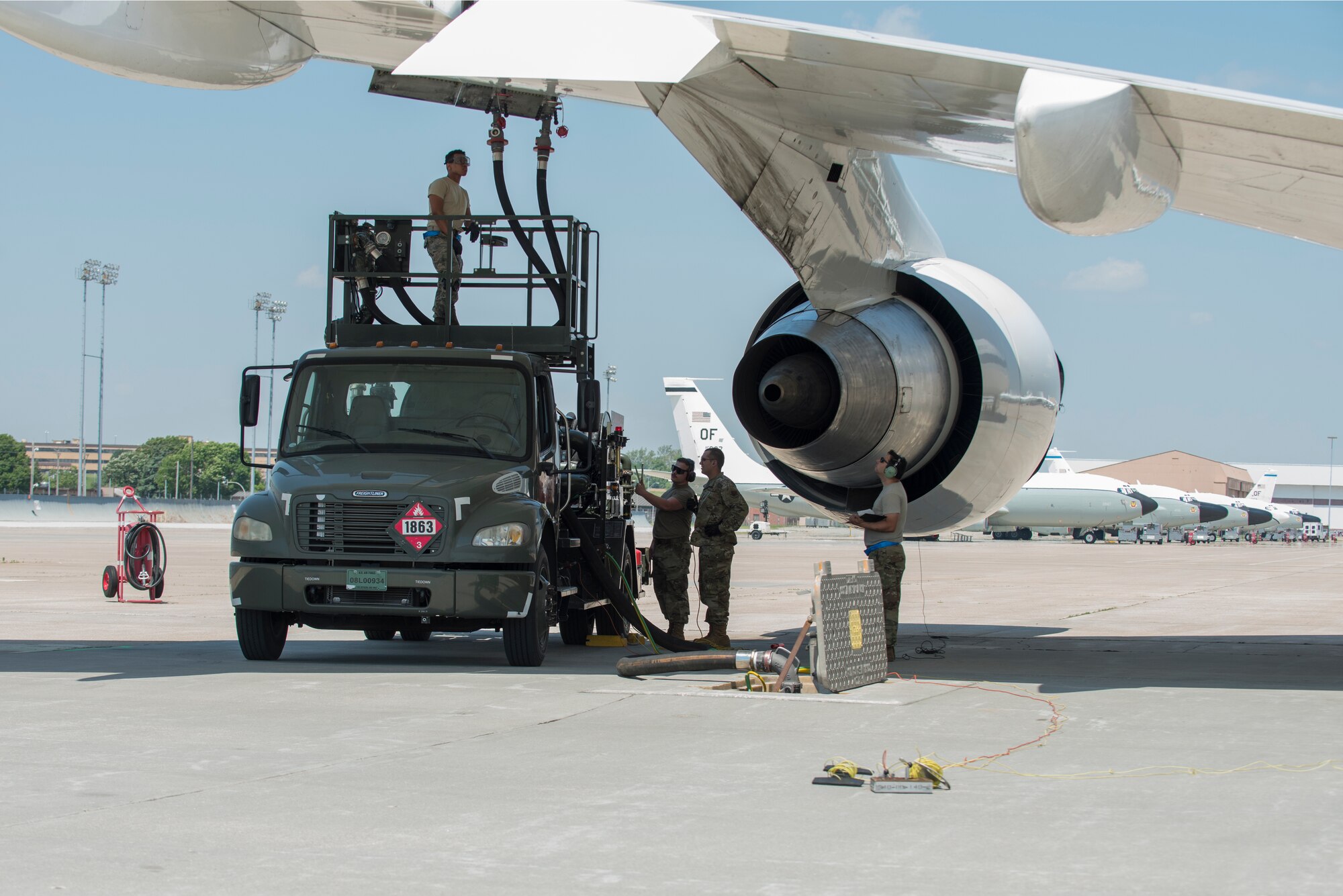 A team looks on as an aircraft is refueled.