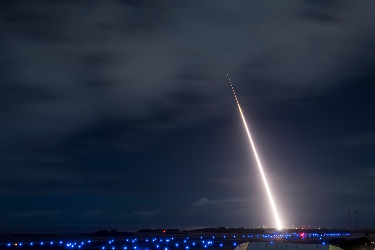 A rocket launches into a night sky.