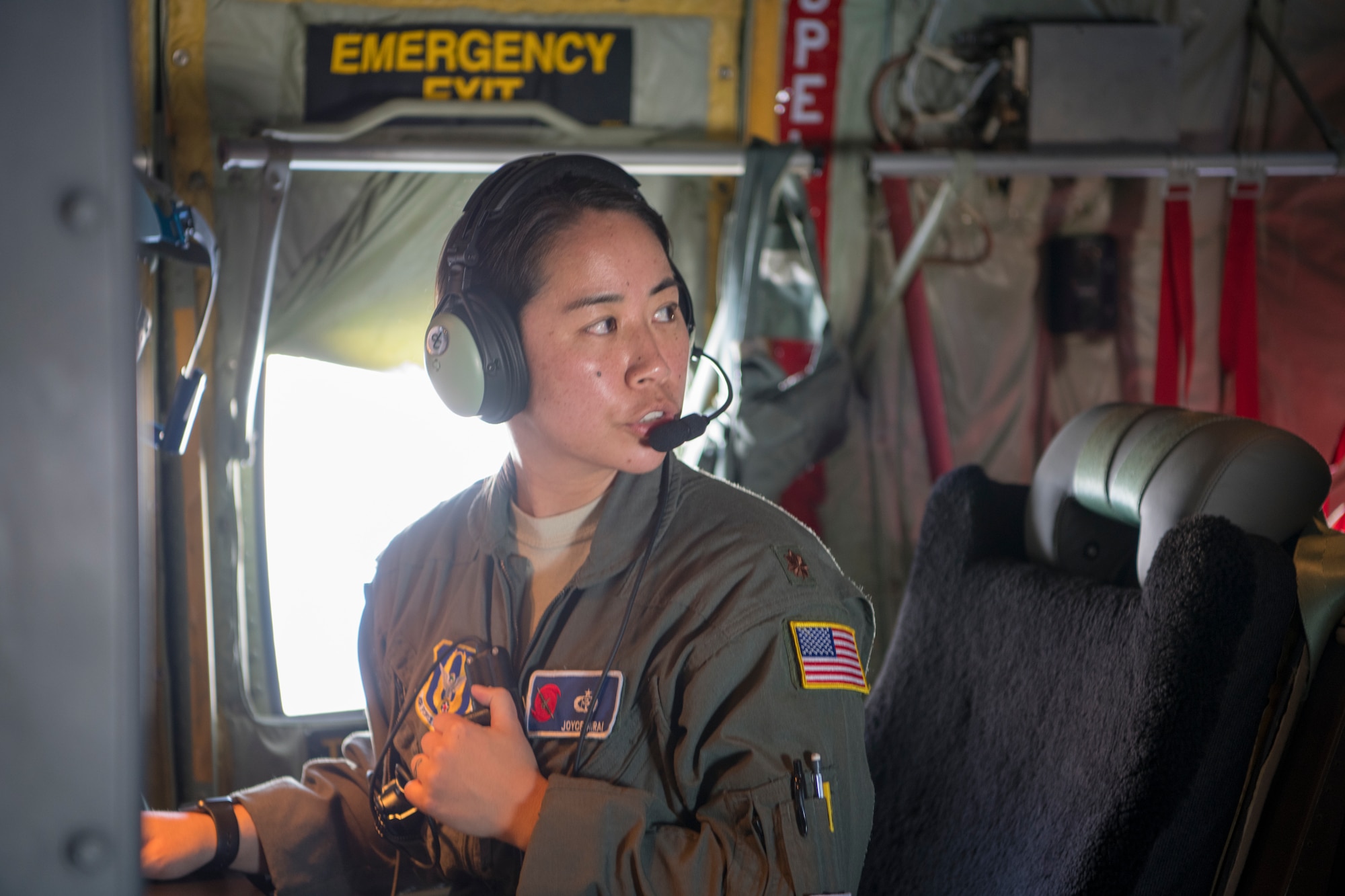 Maj. Joyce Hirai, 53rd Weather Reconnaissance Squadron aerial reconnaissance weather officer, talks over the radio during a flight over St. Croix, U.S. Virgin Islands, June 17. The Hurricane Hunters deployed to St. Croix to fly training missions over the Caribbean in preparation for the 2020 hurricane season. (U.S. Air Force photo by Tech. Sgt. Christopher Carranza)