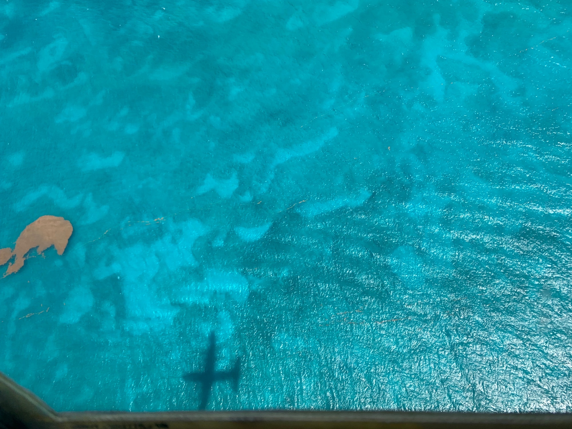 The shadow of  WC-130J Super Hercules aircraft over the water June 17, near St. Croix, U.S. Virgin Islands. The Hurricane Hunters deployed to St. Croix, to fly training missions over the Caribbean in preparation for the 2020 hurricane season. (U.S. Air Force photo by Tech. Sgt. Christopher Carranza)