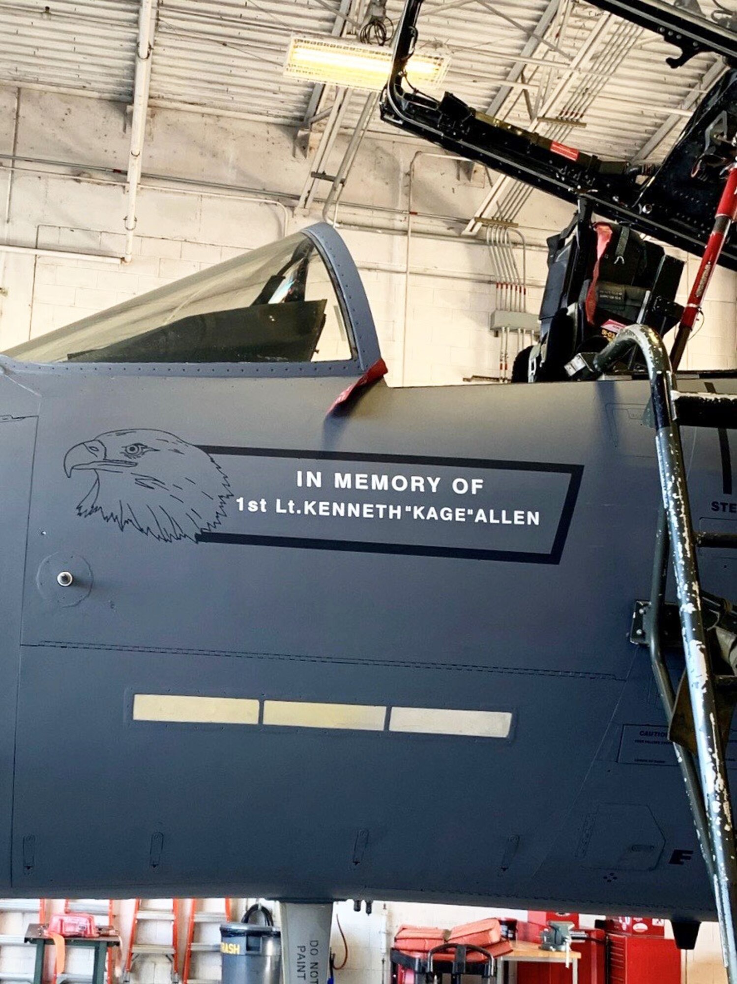 Photo shows close up view of name painted unto F-15 below the cockpit.