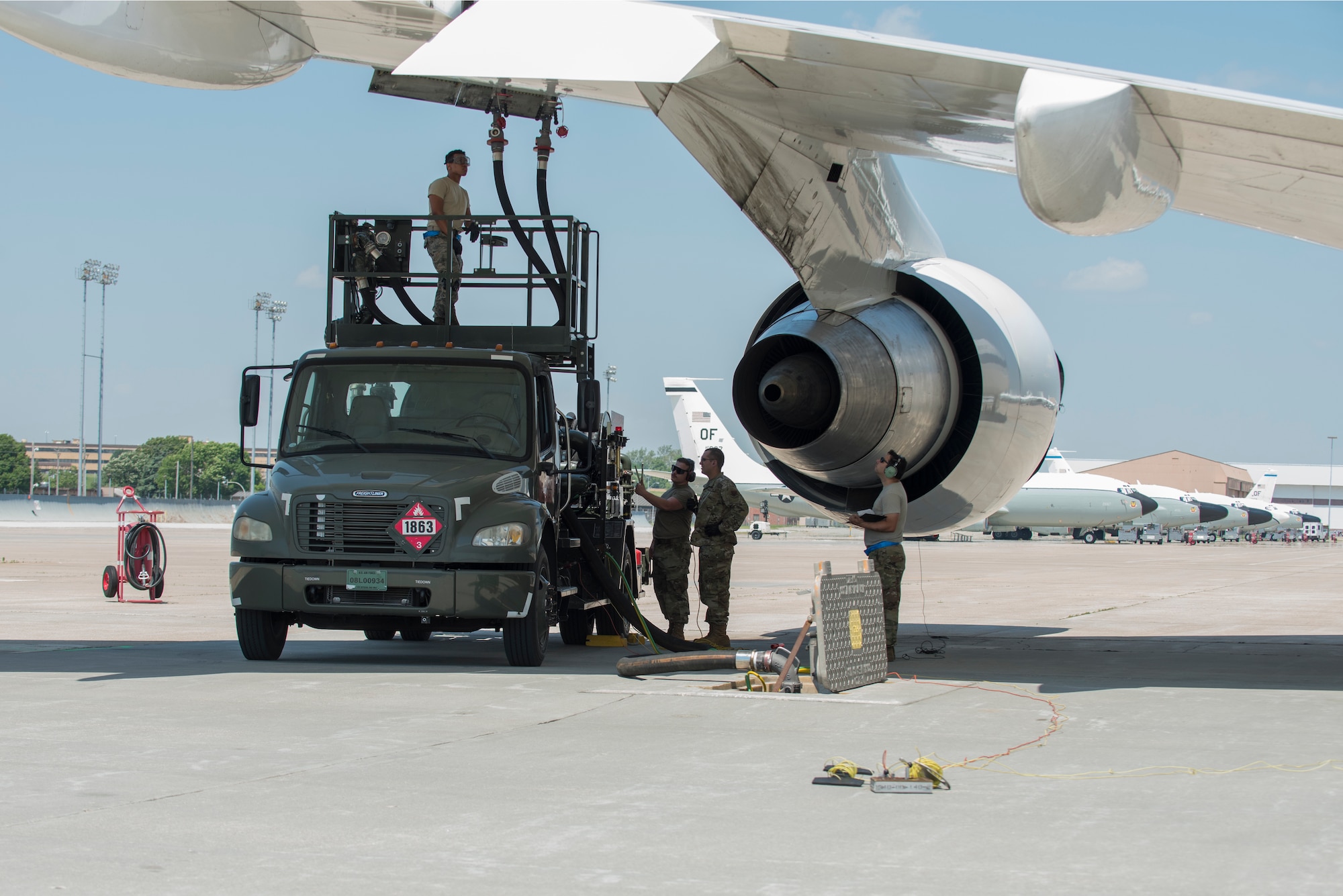 A team looks on as an aircraft is refueled.