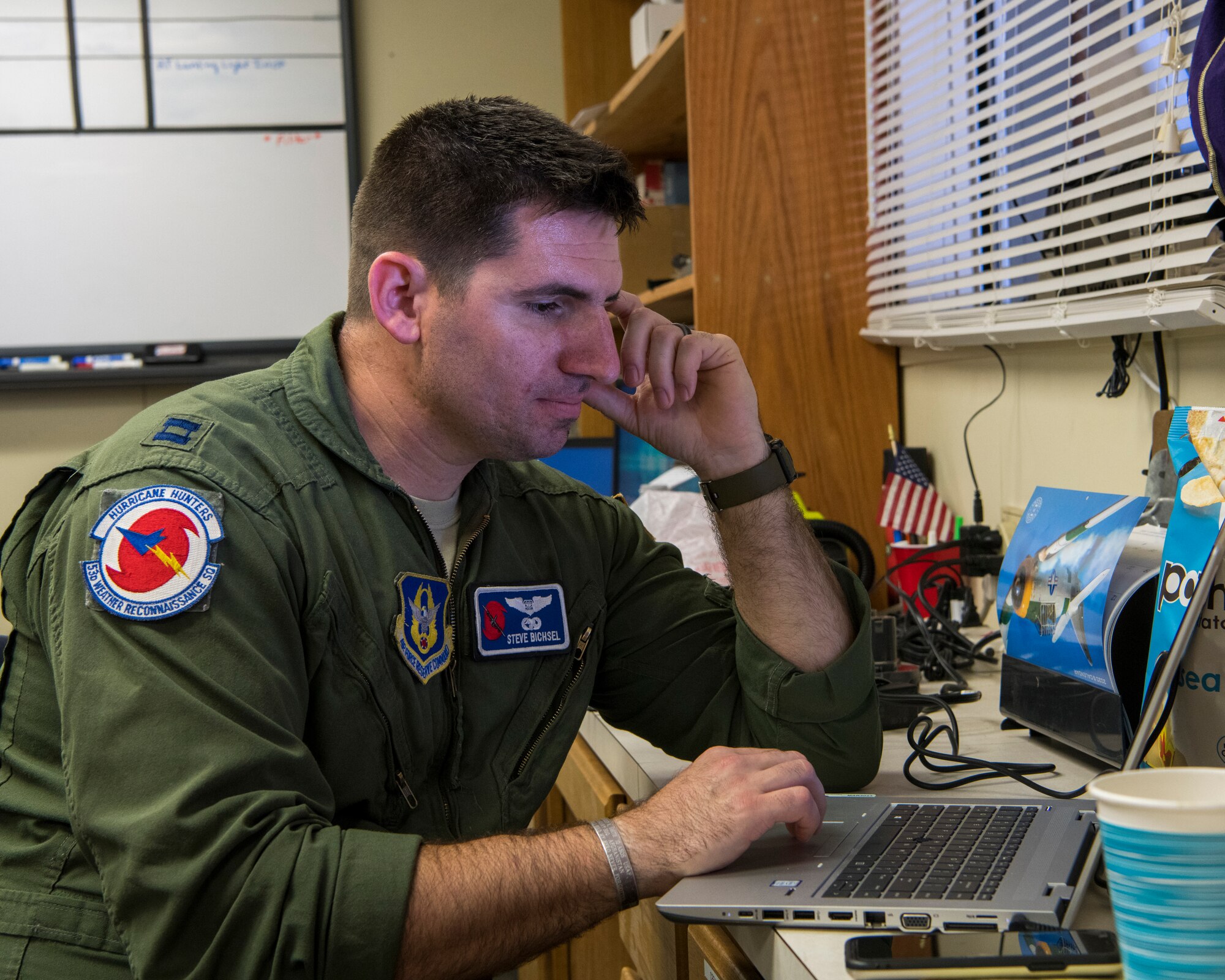 Capt. Steve Bichsel, 53rd Weather Reconnaissance Squadron navigator, types up a report, June 16, at St. Croix, U.S. Virgin Islands.  The Hurricane Hunters deployed to St. Croix to fly training missions over the Caribbean in preparation for the 2020 hurricane season. (U.S. Air Force photo by Tech. Sgt. Christopher Carranza)