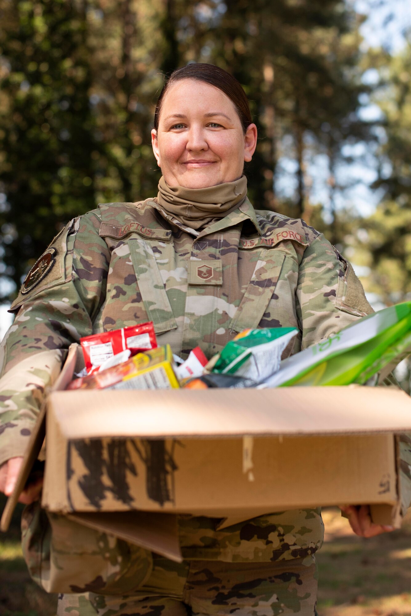 Master Sgt. Aisling Loftus, 100th Force Support Squadron postal superintendent, with a care package she assembled at RAF Mildenhall, England, June 15, 2020. Team Mildenhall has donated approximately 3,000 items to support the wellness of local healthcare workers fighting COVID-19. (U.S. Air Force photo by Airman 1st Class Joseph Barron)