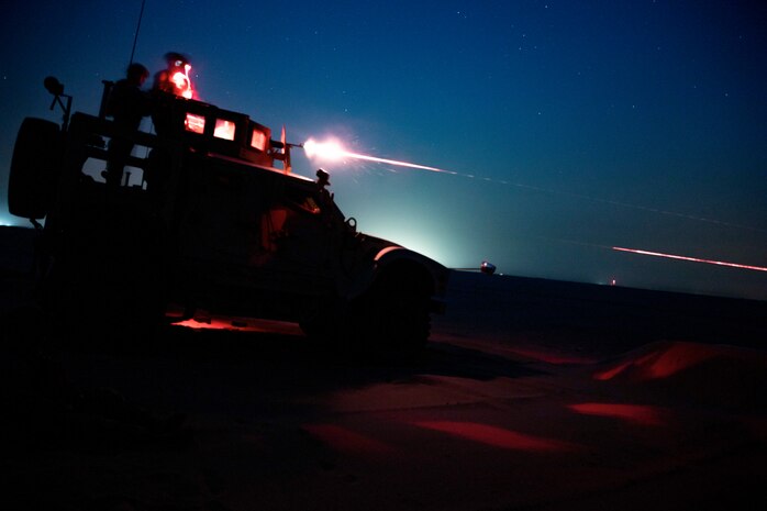 U.S. Marines fire an M240B from an MRAP All-Terrain Vehicle on a night time machine gun range in Kuwait, June 16.