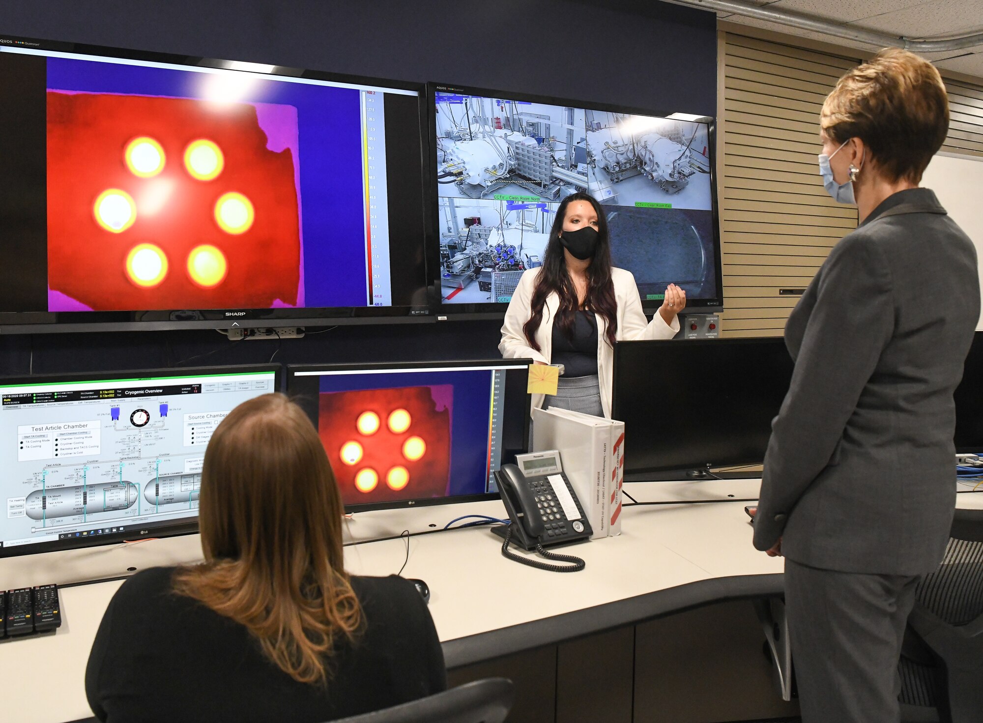 Kellye Burns, center, a space test engineer, explains to Secretary of the Air Force Barbara Barrett a materials test that was conducted in the Space Threat Assessment Testbed to understand the performance of the materials and susceptibility to a realistic space environment at Arnold Air Force Base, Tenn., June 18, 2020. (U.S. Air Force photos by Jill Pickett)