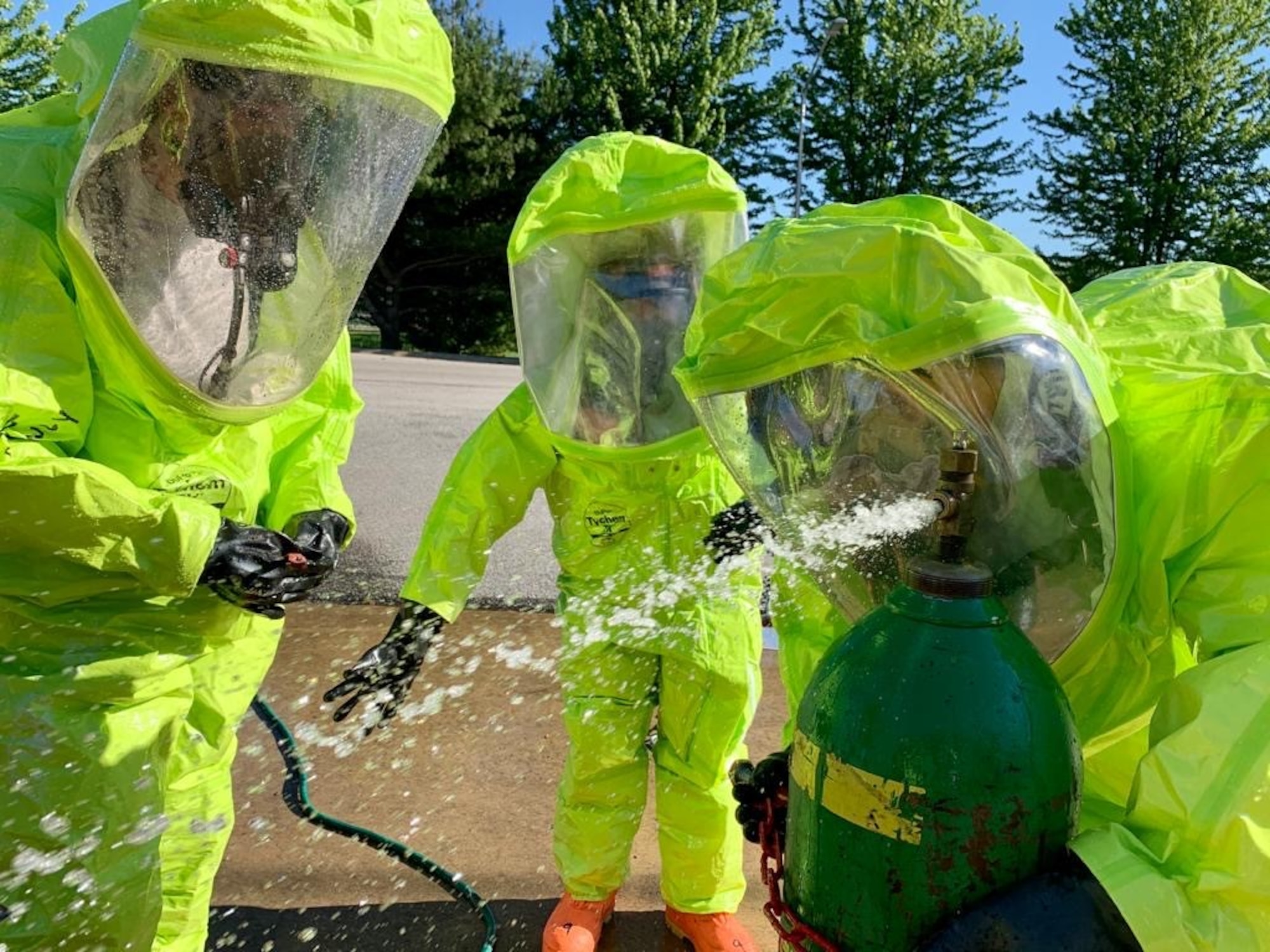 Staff Sgt. Patrick Iliff, Senior Airman Eva Chupp, and Master Sgt. Anthony Chico, 434th Civil Engineering Squadron emergency management apprentices, cap a simulated leak on a chlorine canister. Emergency managers must be prepared at all times to respond to manmade and natural disasters both on base and in deployed locations at any time. (U.S. Air Force photo / Staff Sgt. Clint Hazlett