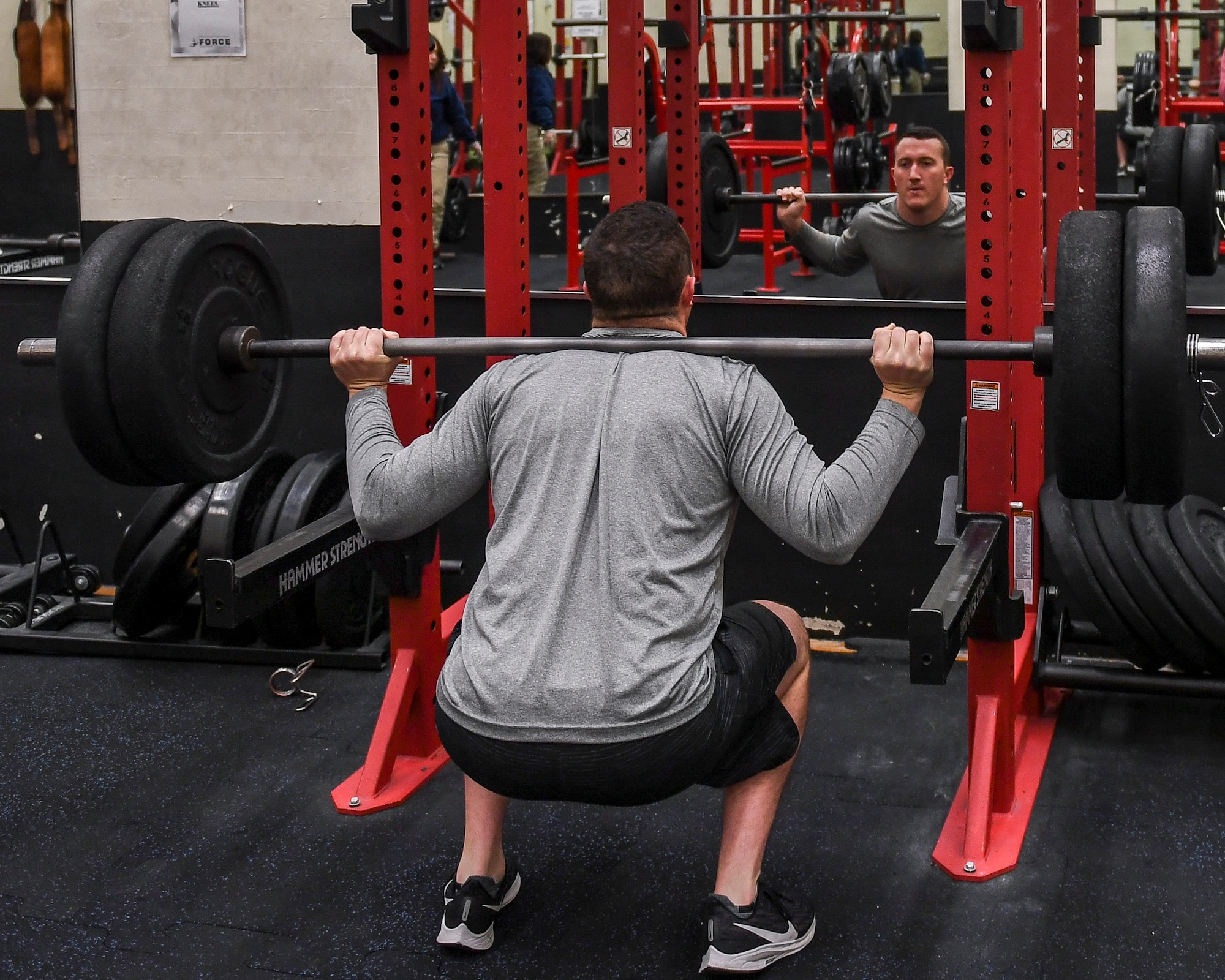 A person performing the squat exercise.