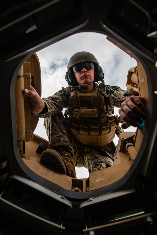 U.S Marine Corps Lance Cpl. Kenneth Shirley, a Pearl, Mississippi native and assault breach vehicle operator with 2d Combat Engineer Battalion (CEB), 2d Marine Division, poses on top of an M1 assault breach vehicle at Camp Lejeune, North Carolina, June 16, 2020. Shirley demonstrated the attributes of a model non-commissioned officer by dedicating his personal time to improving himself through rigorous physical fitness. He ran 31.5 miles in one day during a battalion memorial run for fallen 2d CEB Marines. Shirley was selected as the 2d MARDIV Motivator of the Week for his tireless work ethic and initiative. (U.S. Marine Corps photo by Lance Cpl. Patrick King)