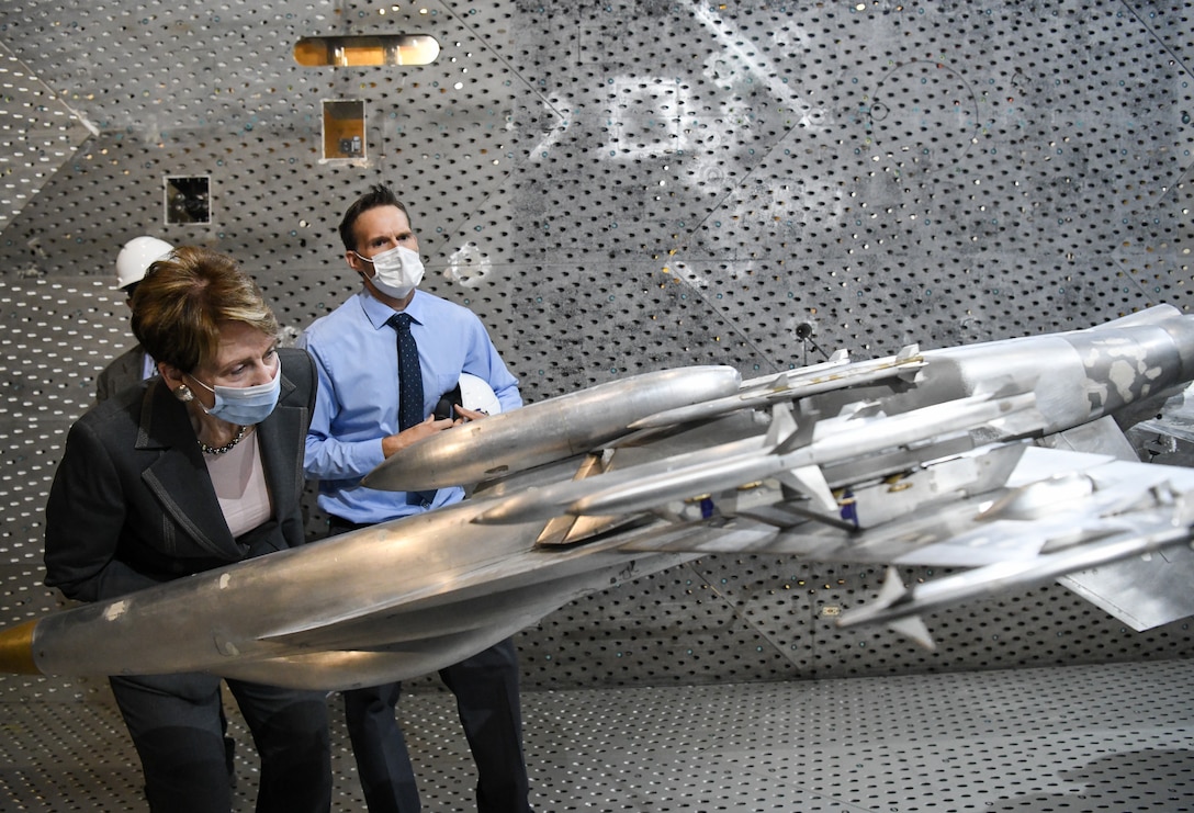 Secretary of the Air Force Barbara Barrett looks at a model of an F-18 Super Hornet in the Arnold Engineering Development Complex 16-foot Transonic Wind Tunnel during her visit, June 18, 2020, to Arnold Air Force Base, Tenn. Also pictured is Dr. Rich Roberts, flight commander for store separation. (U.S. Air Force photo by Jill Pickett)