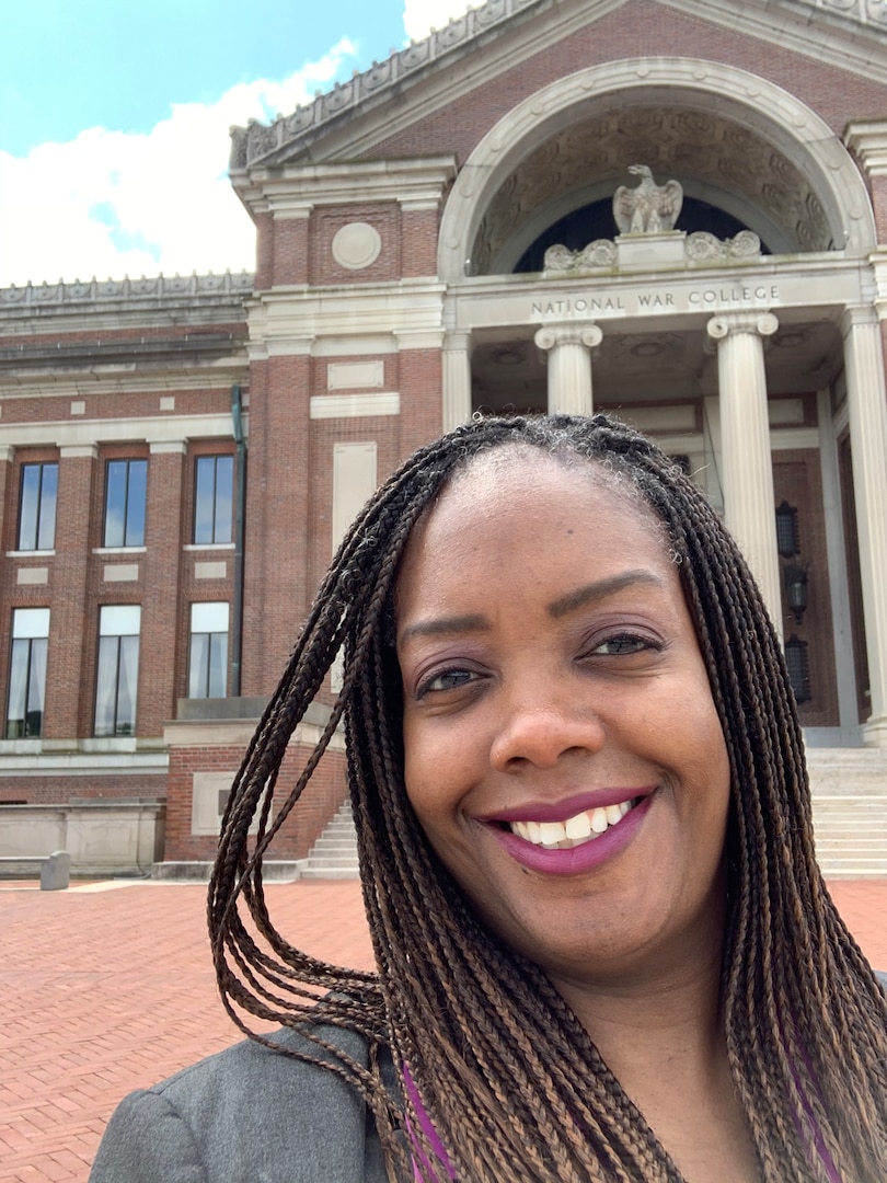 Defense Intelligence Agency officer Kim Hendricks stands at the entrance of the National War College, part of the National Defense University. Hendricks recently earned the honor of distinguished graduate from her time at NWC. (Photo courtesy of Kim Hendricks)