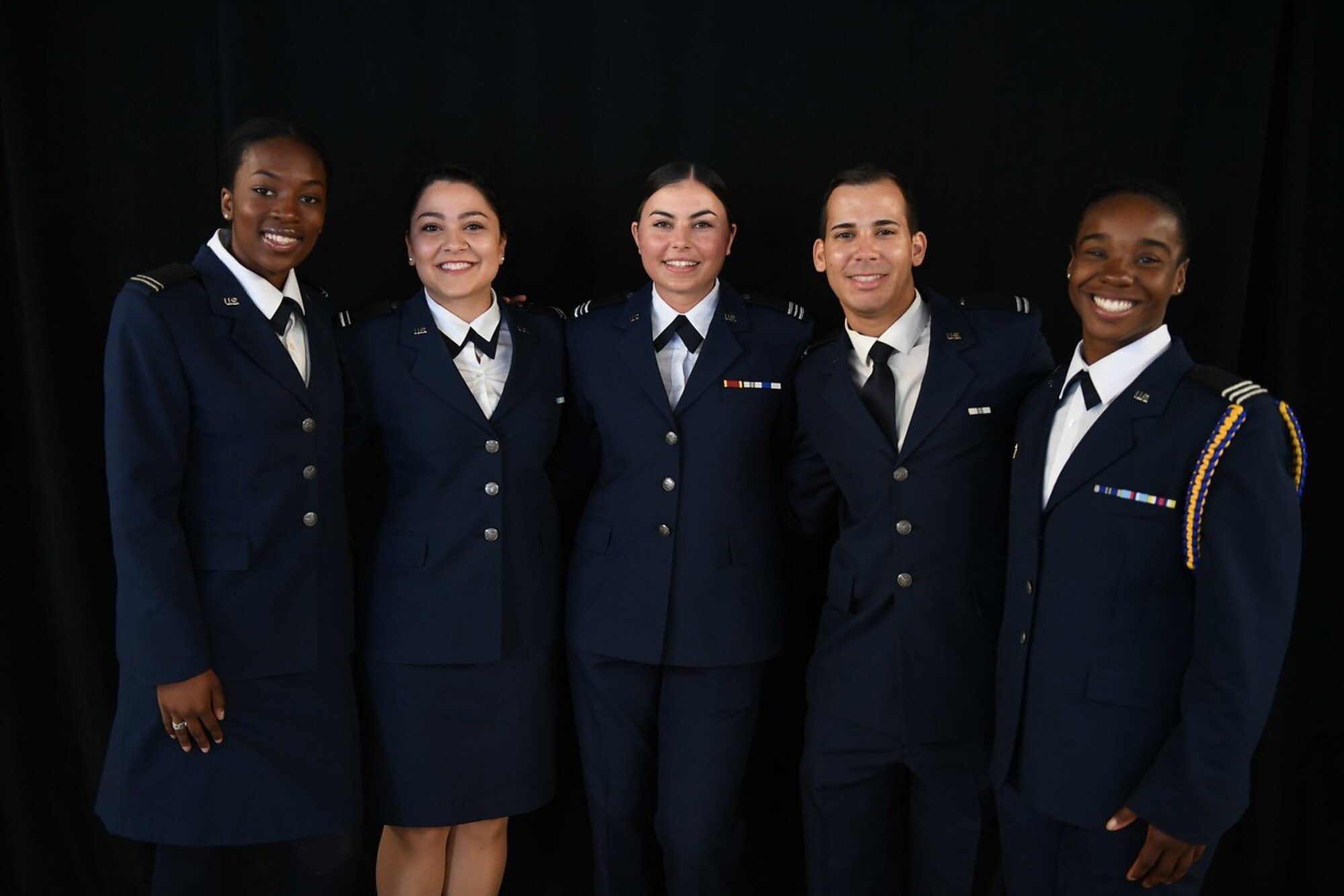 U.S. Air Force 2nd Lt. Amirah Latiff, 2nd Lt. Gabrielle Payne, 2nd Lt. Kennedy DiBerardino, 2nd Lt. Julian Lawson, and 2nd Lt. Destini Hamilton, pose for a photo in their ROTC attire.