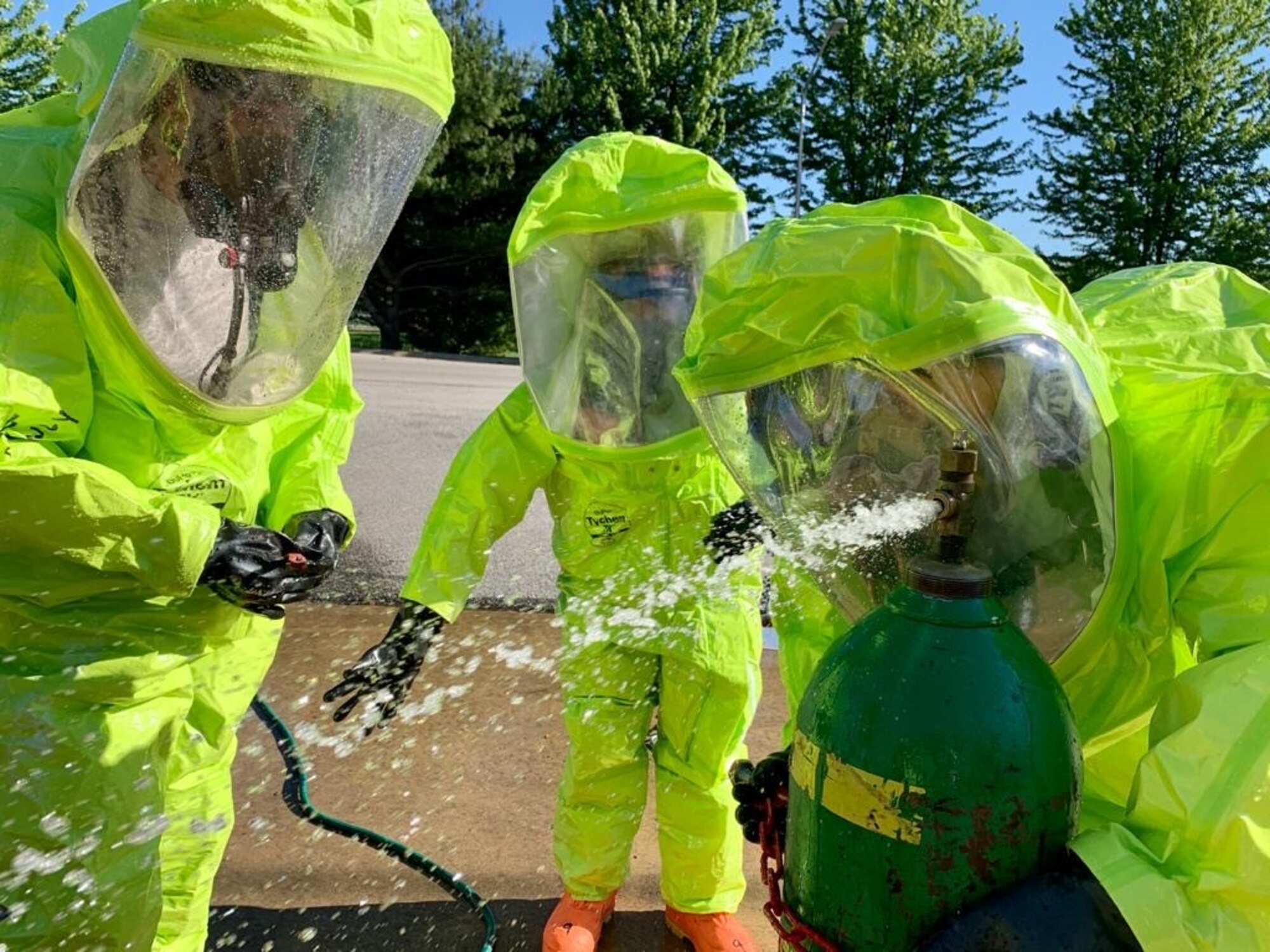 Staff Sgt. Patrick Iliff, Senior Airman Eva Chupp, and Master Sgt. Anthony Chico, 434th Civil Engineering Squadron emergency management apprentices, cap a simulated leak on a chlorine canister. Emergency managers must be prepared at all times to respond to manmade and natural disasters both on base and in deployed locations at any time. (U.S. Air Force photo / Staff Sgt. Clint Hazlett