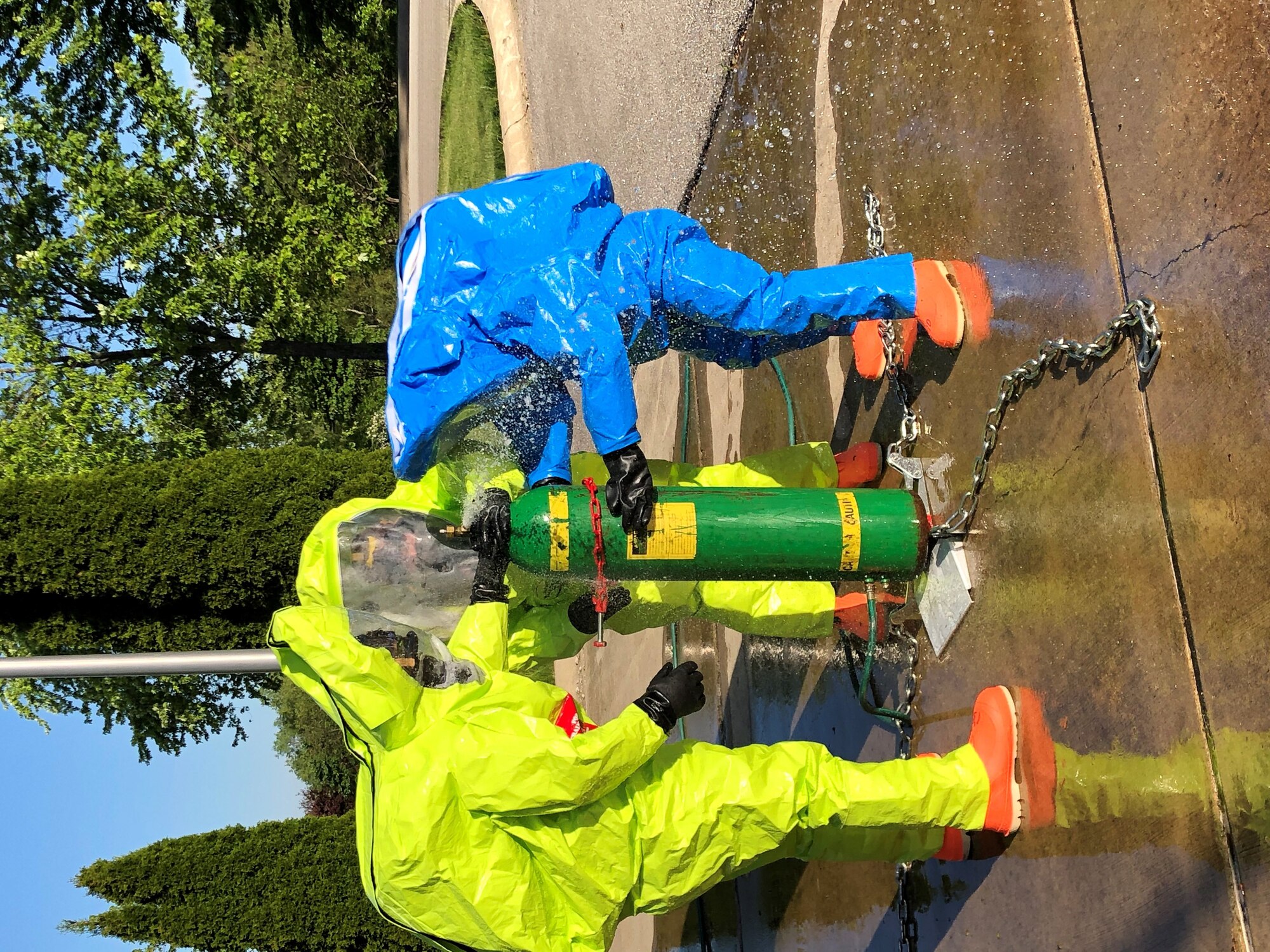 Senior Master Sgt. Jon Raschke, Senior Airman Sarah Howell, and Staff Sgt. Lauren Storms, 434th Civil Engineering Squadron emergency management apprentices, cap a simulated leak on a chlorine canister. Emergency managers must be prepared at all times to respond to manmade and natural disasters both on base and in deployed locations at any time. (U.S. Air Force photo / Staff Sgt. Clint Hazlett