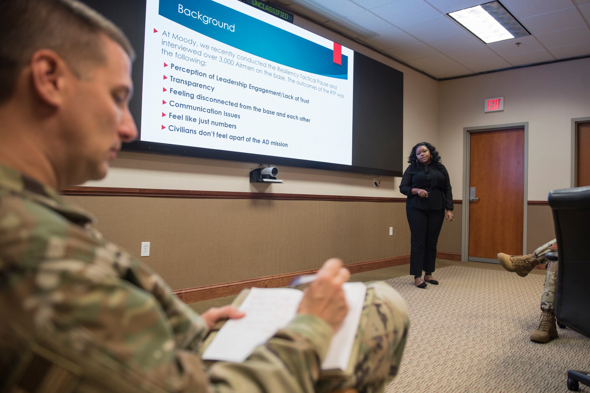 A photo of a Lt. Col. taking notes.