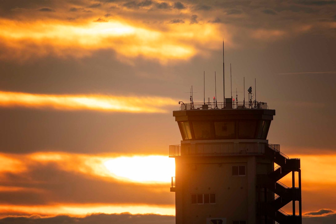 The sun shines on an air traffic control tower.