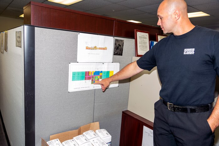 Ryan Tworek, deputy fire chief, Marine Corps Logistics Base Fire Department, indicates where his new office will be located in building 322 once the buildout has been completed, June 9.