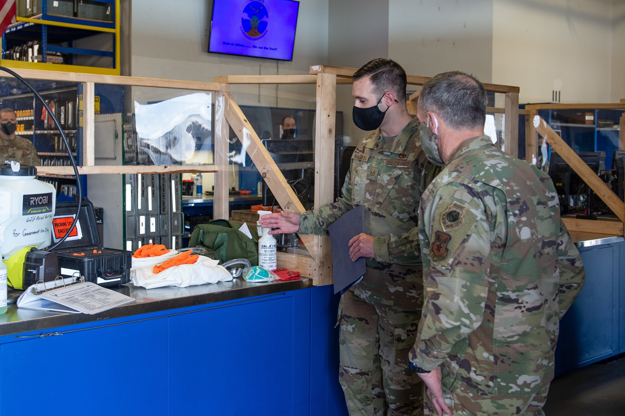Tech. Sgt. Nathan Nachatilo, 62nd Aircraft Maintenance Squadron, left, explains the process of aircraft decontamination to Gen. David Goldfein, chief of staff of the Air Force, right, at Joint Base Lewis-McChord, Wash., June 18, 2020. During his tour of Team McChord, Goldfein visited the Western Air Defense Sector, 62nd Maintenance Squadron, 62nd Aircraft Maintenance Squadron and the 7th and 4th Airlift Squadrons to see how their mission shave been impacted by COVID-19. (U.S. Air Force photo by Senior Airman Sara Hoerichs)
