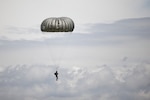 A Soldier with the North Carolina Army National Guard drifts toward a field at the Stanley County Regional Airport, New London, North Carolina, June 18, 2020. Soldiers with the 403rd Quartermaster Rigger Support Team and B Company, 3rd Battalion, 20th Special Forces Group, were supported by a Black Hawk helicopter team from the 449th Theater Aviation Brigade to perform static-line airborne operations.