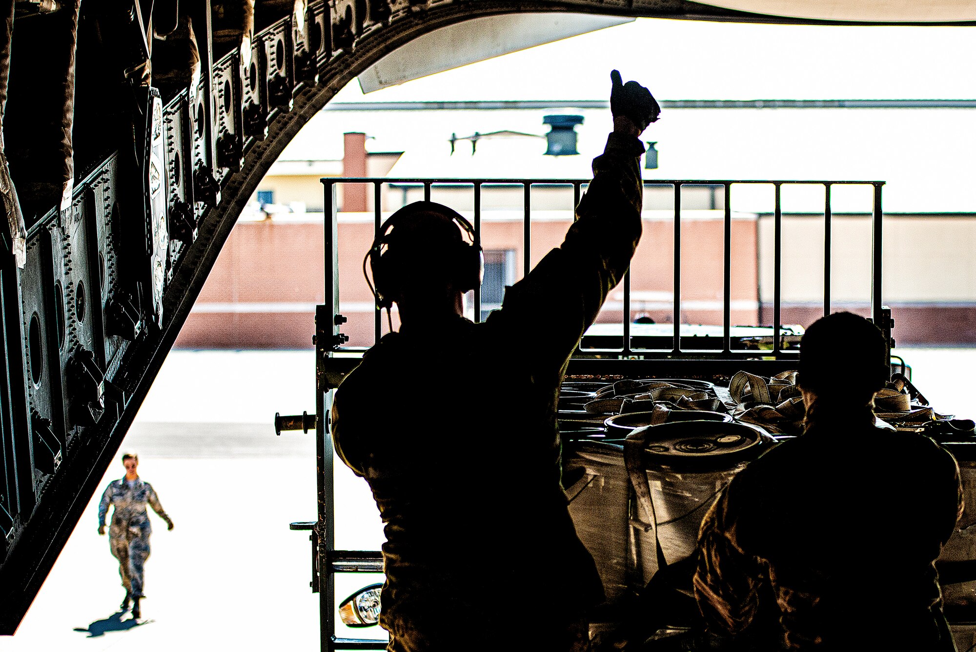 Photo of an Airman signaling "OK" to another service member.