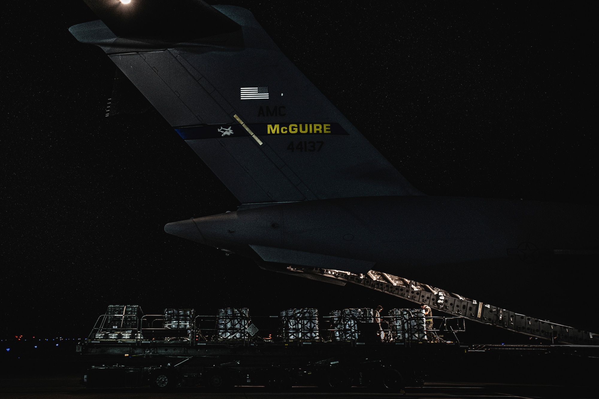 Photo of medical supplies being off-loaded from an aircraft.