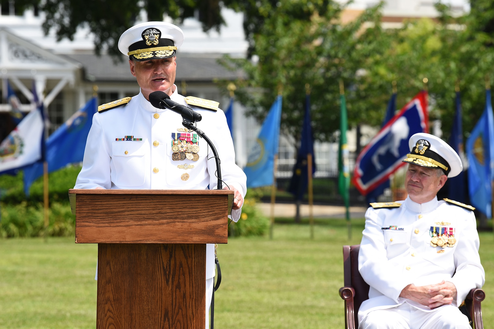 Vice Admiral William J. Galinis, left, speaks as Vice Admiral Thomas Moore looks on during a Change of Command ceremony for Naval Sea Systems Command (NAVSEA). Galinis took over for Moore as Commander, NAVSEA during the ceremony held in Leutze Park at Washington Navy Yard.