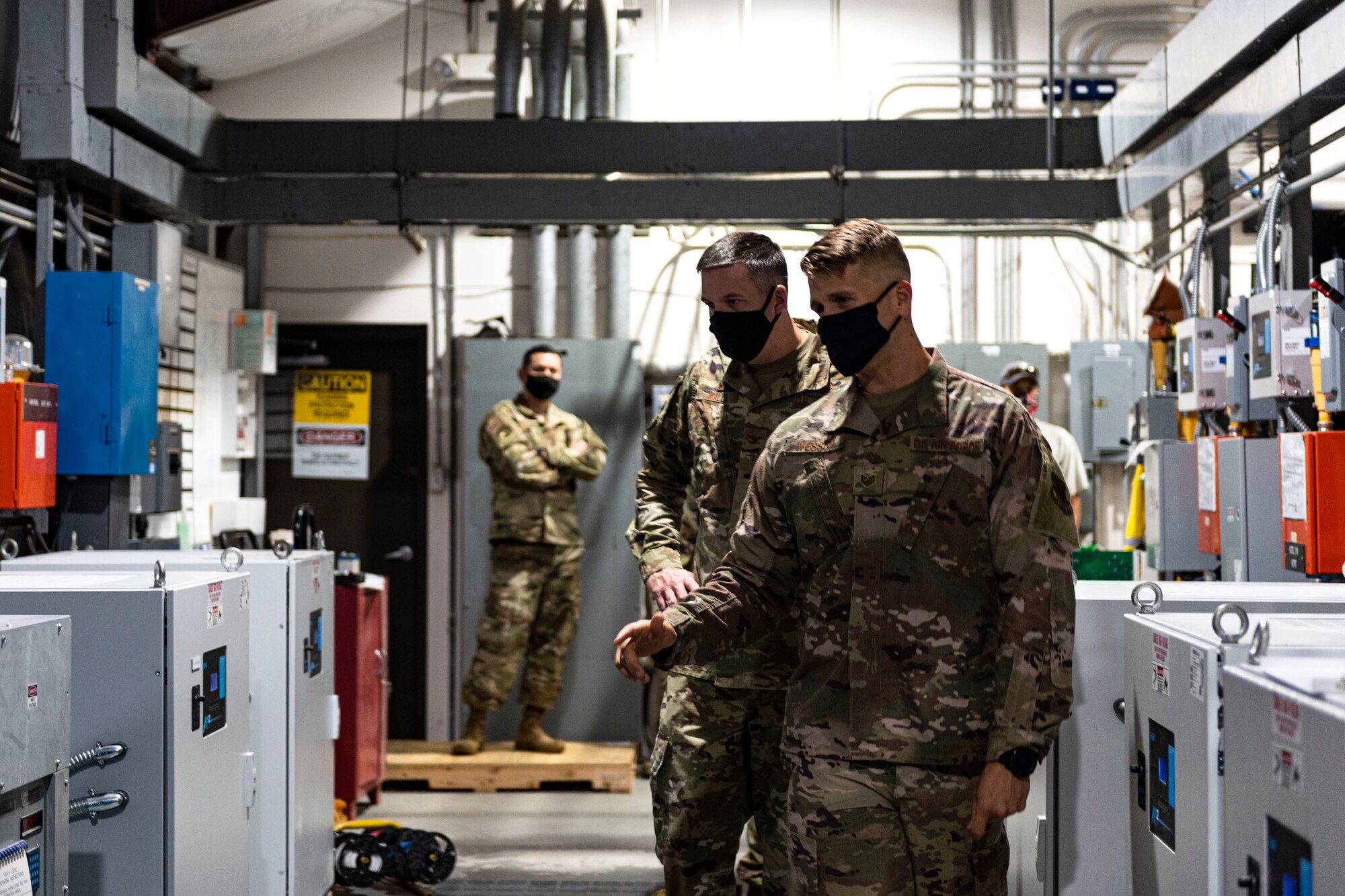 Photo of Airman explaining voltage regulator functionality.