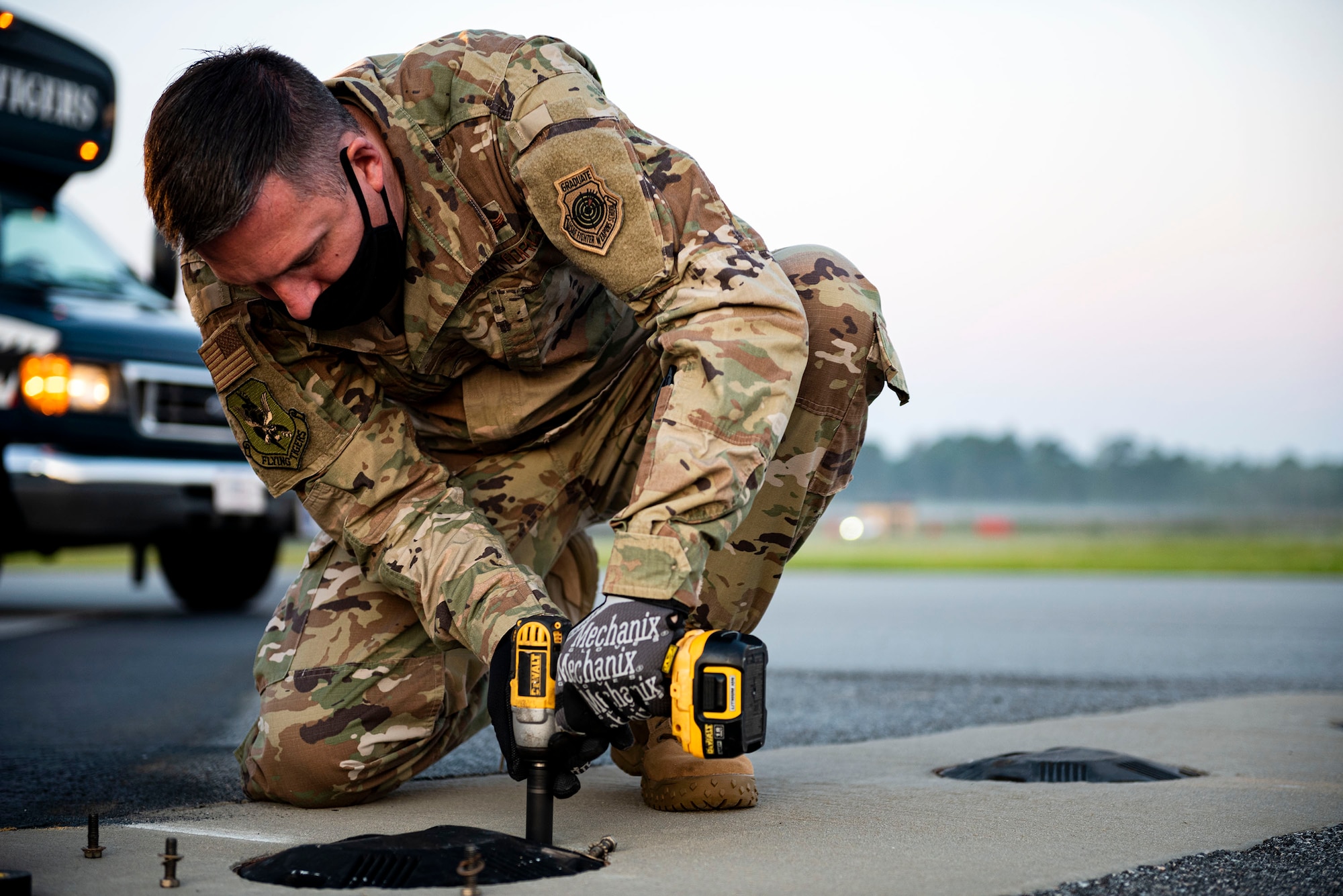 Photo of commander replacing an airfield light.