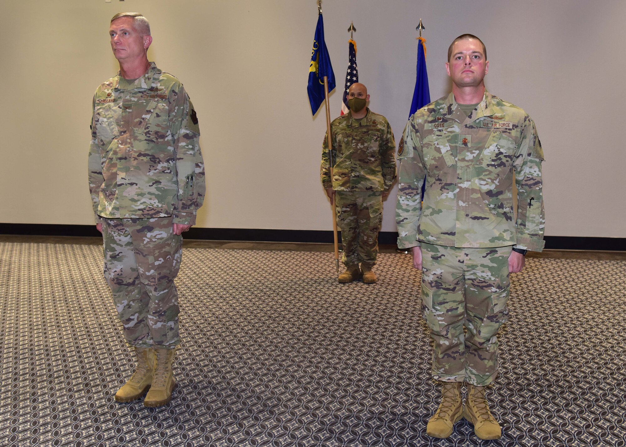 U.S. Air Force Col. Tony England, 17th Mission Support Group commander, and Maj. David Cote, 17th Communications Squadron outgoing commander, stand at attention during the presentation of the Meritorious Service Medal to Cote during the 17th CS Change of Command ceremony on Goodfellow Air Force Base, Texas, June 18, 2020. Cote relinquished command to Maj. William Bennett in the time-honored tradition which is meant to introduce a new leader to the troops under their charge. (U.S. Air Force photo by Staff Sgt. Chad Warren)