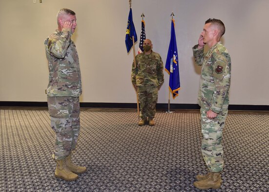 U.S. Air Force Maj. William Bennett, 17th Communications Squadron commander, right, assumes command from presiding official Col. Tony England, 17th Mission Support Group commander, during the 17th CS Change of Command ceremony on Goodfellow Air Force Base, Texas, June 18, 2020. Bennett took over the squadron from Maj. David Cote, former 17th CS commander, who led the unit for the past two years. (U.S. Air Force photo by Staff Sgt. Chad Warren)
