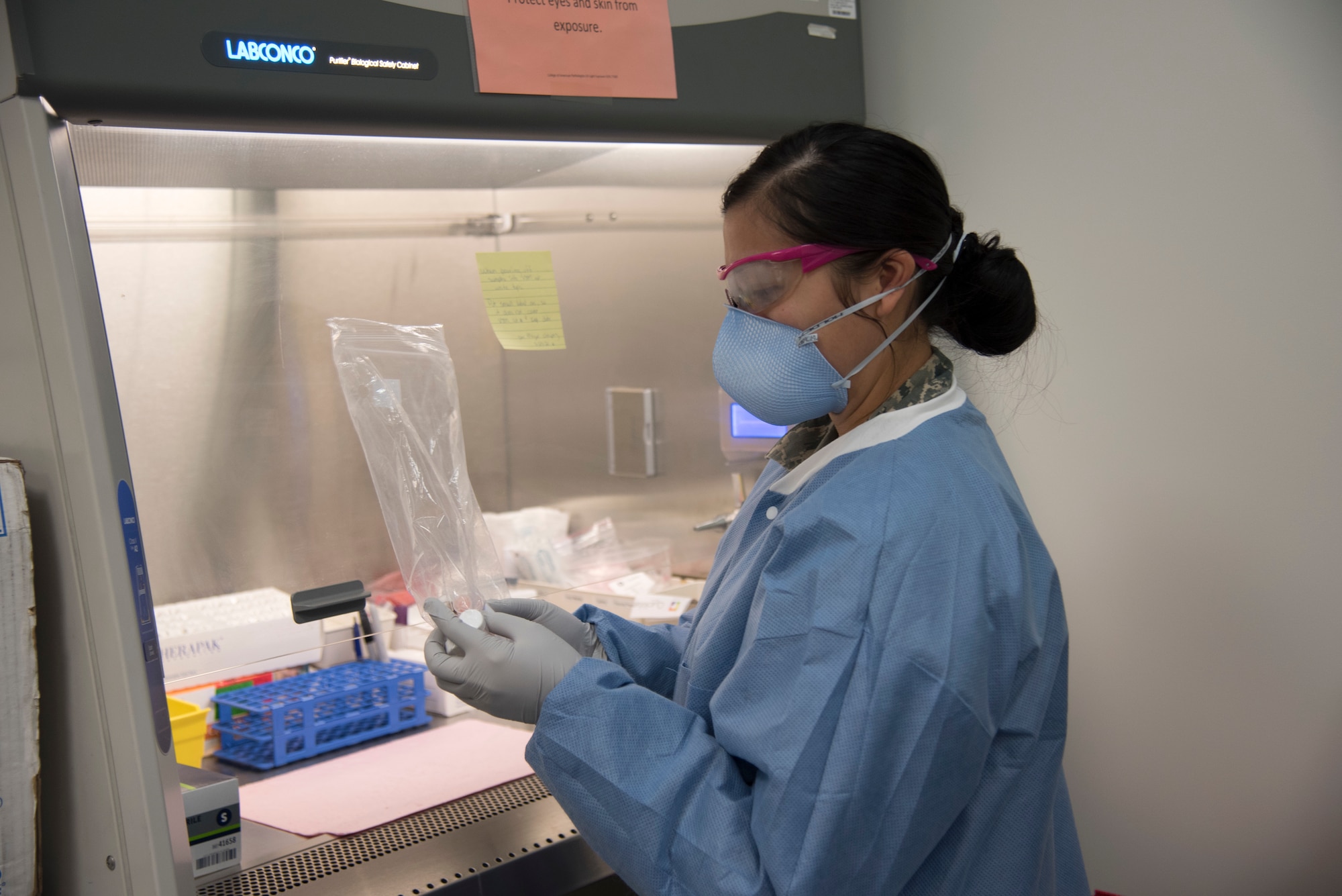 PETERSON AIR FORCE BASE, Colo. - Senior Airman Trisha Lariza, a medical laboratory technician at the 21st Medical Group clinical laboratory, prepares to transfer a COVID-19 nasal swab to viral transport media before it’s shipped out for testing. The lab at Peterson Air Force Base, Colorado, generates more than 4,700 lab results on average each month. (U.S. Air Force photo by Kristen Allen)