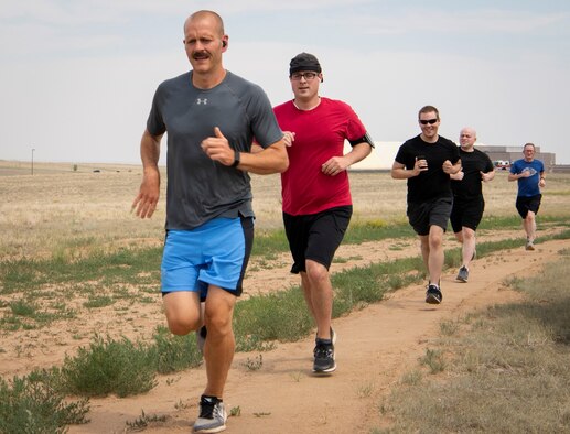 Airmen run during a watermelon run June 17, 2020, at Schriever Air Force Base, Colorado. The activity is organized by Joggernauts running club, which meets at Schriever Wednesdays at 3 p.m. at the base fitness center and Saturdays at 8 a.m. in various locations around Colorado Springs. (U.S. Air Force photo by Airman 1st Class Jonathan Whitely)