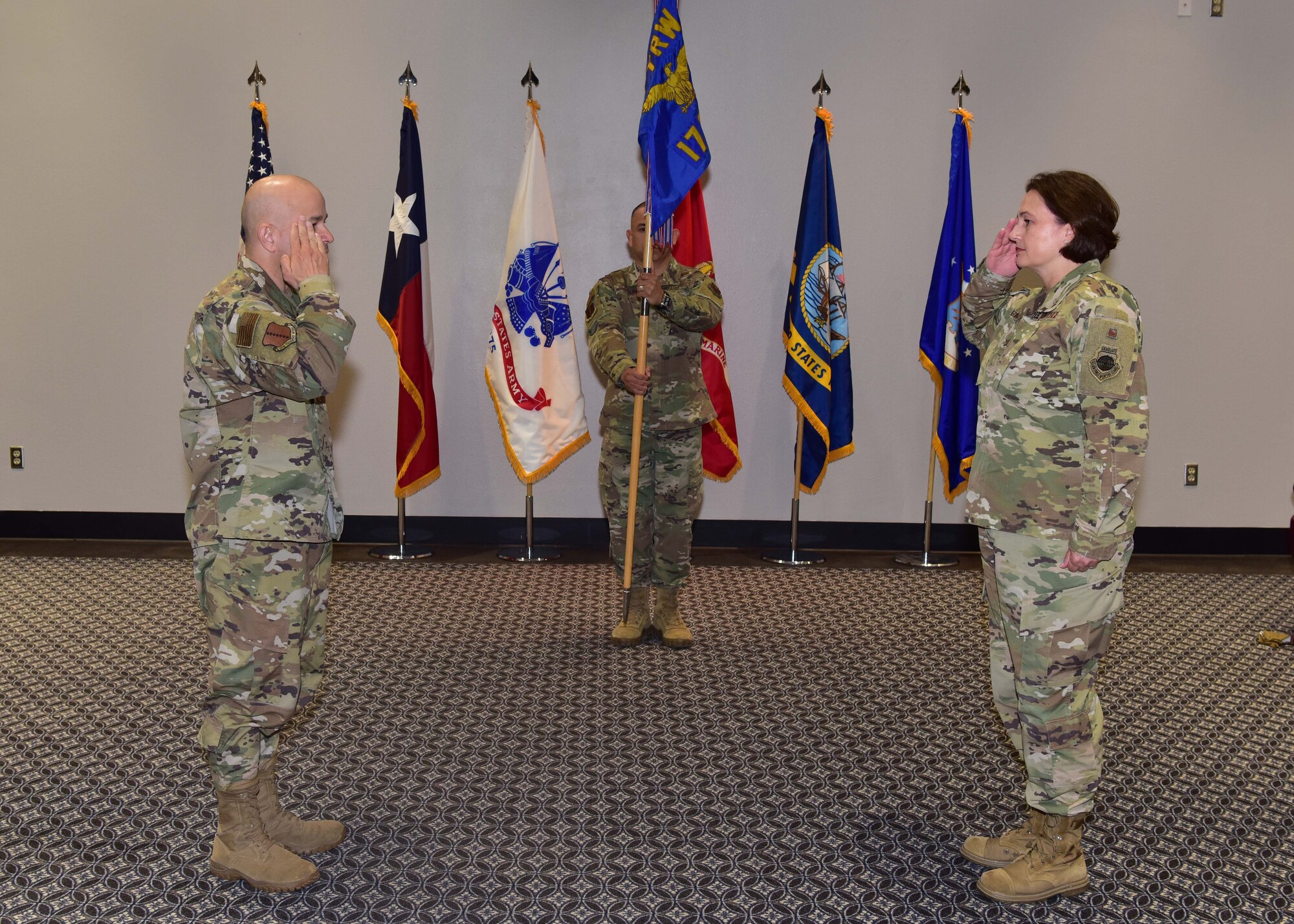 U.S. Air Force Col. Angelina Maguiness, 17th Training Group commander, assumes command from presiding official Col. Andres Nazario, 17th Training Wing commander, during the 17th TRG Change of Command ceremony on Goodfellow Air Force Base, Texas, June 18, 2020. Maguinness took over the group from Col. Thomas Coakley, former 17th TRG commander, who led the unit for the past two years. (U.S. Air Force photo by Staff Sgt. Chad Warren)