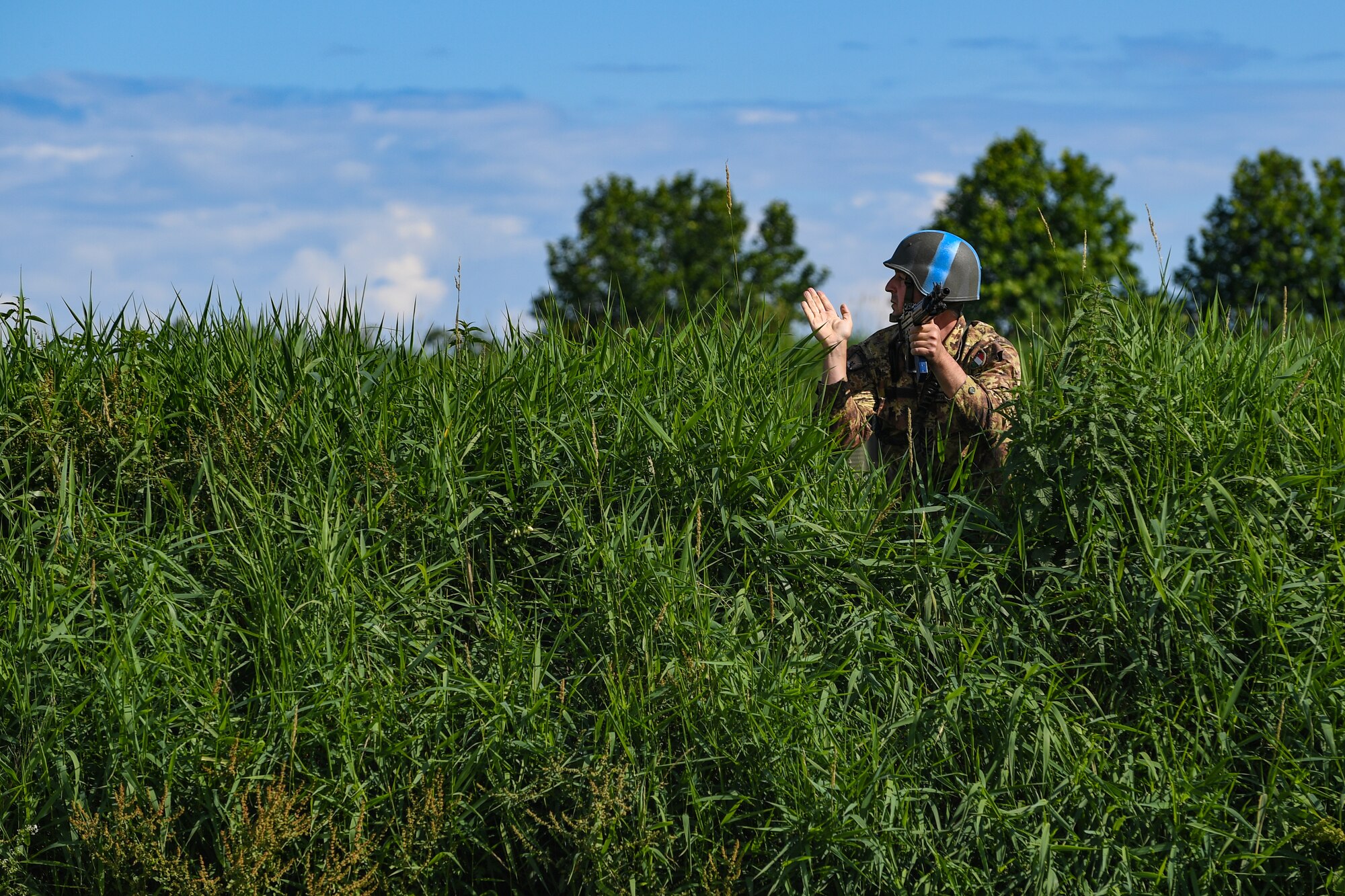 Italian Air Force members perform a perimeter patrol during an exercise at Rivolto Air Base, Italy, June 11, 2020. Italian Air Force security forces volunteers played the role of the opposing force during the exercise and were tasked with patrolling the perimeter to spot suspicious activity. (U.S. Air Force photo by Airman 1st Class Thomas S. Keisler IV)