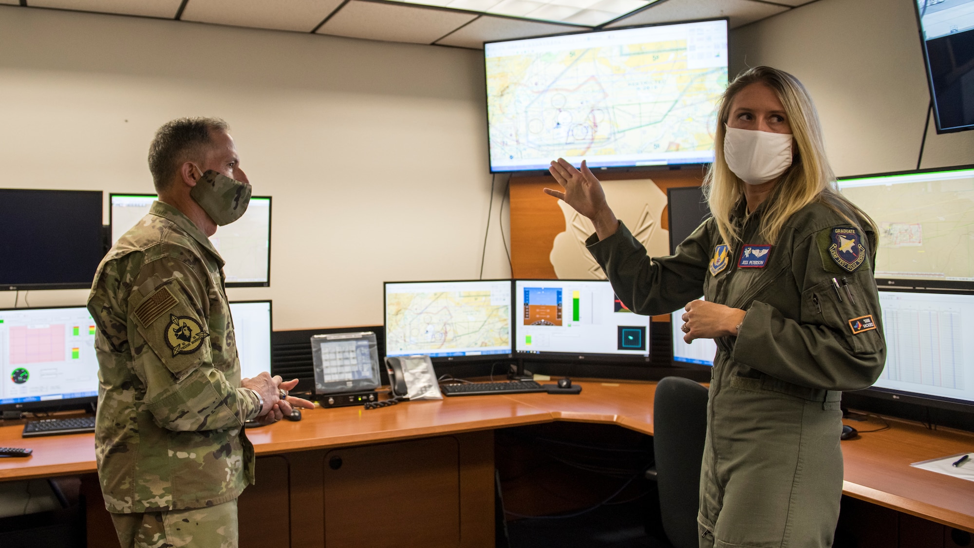 Jess Peterson, U.S. Air Force Test Pilot School instructor, explains the school’s COVID-19 response from inside a mission control at TPS on Edwards Air Force Base, California, June 17. (Air Force photo by Giancarlo Casem)