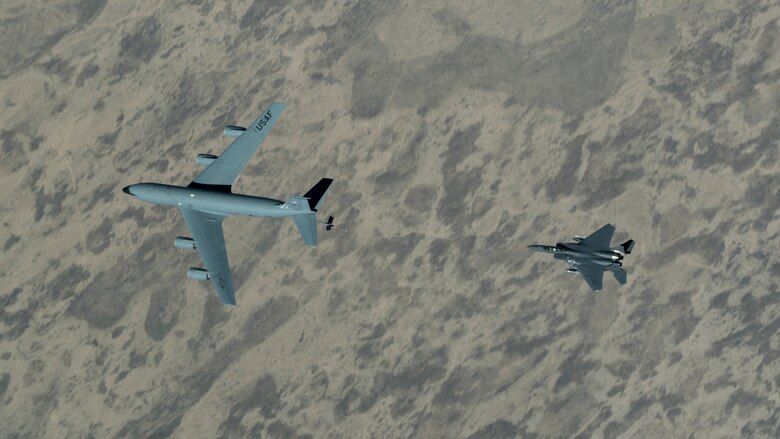 An F-15E Strike Eagle assigned to the 492nd Expeditionary Fighter Squadron approaches a KC-135 Stratotanker with the 28th Expeditionary Air Refueling Squadron over the U.S. Central Command area of responsibility, June 12, 2020. The 28th EARS, deployed with U.S. Air Forces Central Command, is responsible for delivering fuel to U.S. and coalition forces providing air power, deterrence and stability to the region. (U.S. Air Force photo by Senior Airman Brandon Cribelar)