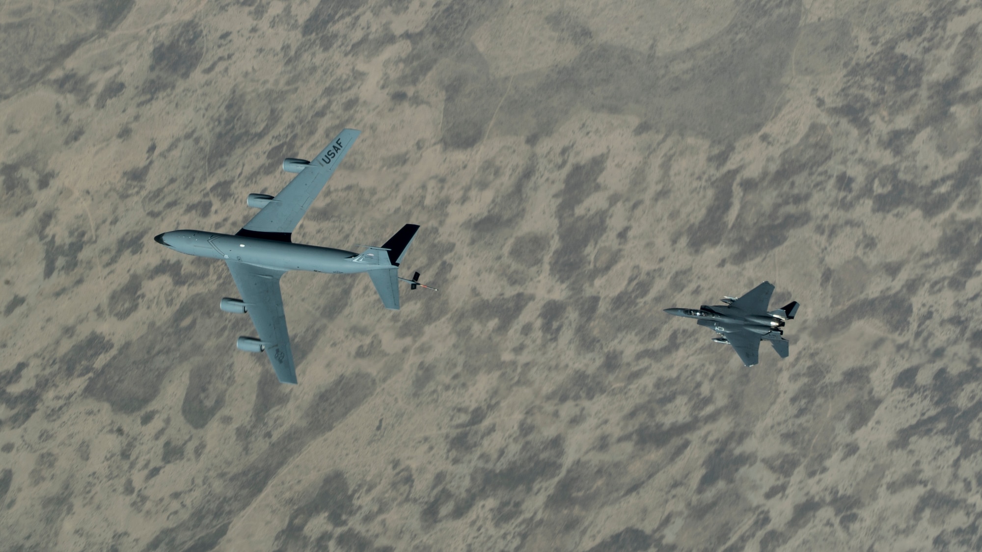 An F-15E Strike Eagle assigned to the 492nd Expeditionary Fighter Squadron approaches a KC-135 Stratotanker with the 28th Expeditionary Air Refueling Squadron over the U.S. Central Command area of responsibility, June 12, 2020. The 28th EARS, deployed with U.S. Air Forces Central Command, is responsible for delivering fuel to U.S. and coalition forces providing air power, deterrence and stability to the region. (U.S. Air Force photo by Senior Airman Brandon Cribelar)