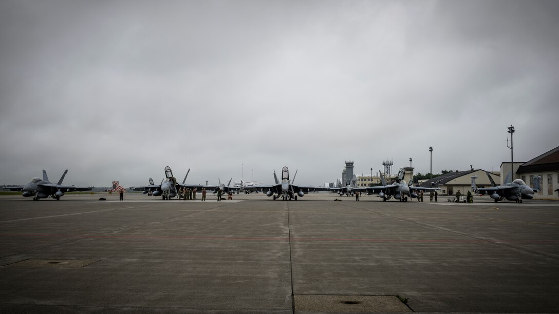 Five U.S. Navy Boeing EA-18Gs sit on the flightline during a PAC Weasel exercise at Misawa Air Base, Japan, June 19, 2020. The objective of this exercise was to integrate U.S. Navy and U.S. Air Force assets to simulate the suppression of enemy air defenses as one cohesive unit, which consisted of 21 aircraft, 16 F-16 Fighting Falcons, four Boeing EA-18G Growlers and a Boeing P-8 Poseidon. (U.S. Air Force photo by Airman 1st Class China M. Shock)