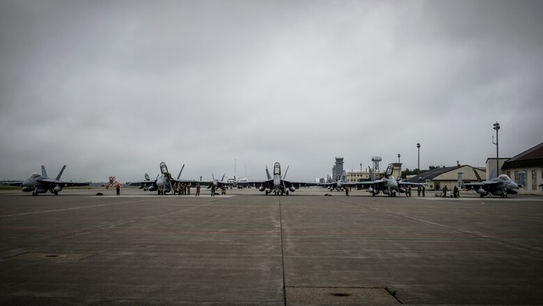 Five U.S. Navy Boeing EA-18Gs sit on the flightline during a PAC Weasel exercise at Misawa Air Base, Japan, June 19, 2020. The objective of this exercise was to integrate U.S. Navy and U.S. Air Force assets to simulate the suppression of enemy air defenses as one cohesive unit, which consisted of 21 aircraft, 16 F-16 Fighting Falcons, four Boeing EA-18G Growlers and a Boeing P-8 Poseidon. (U.S. Air Force photo by Airman 1st Class China M. Shock)