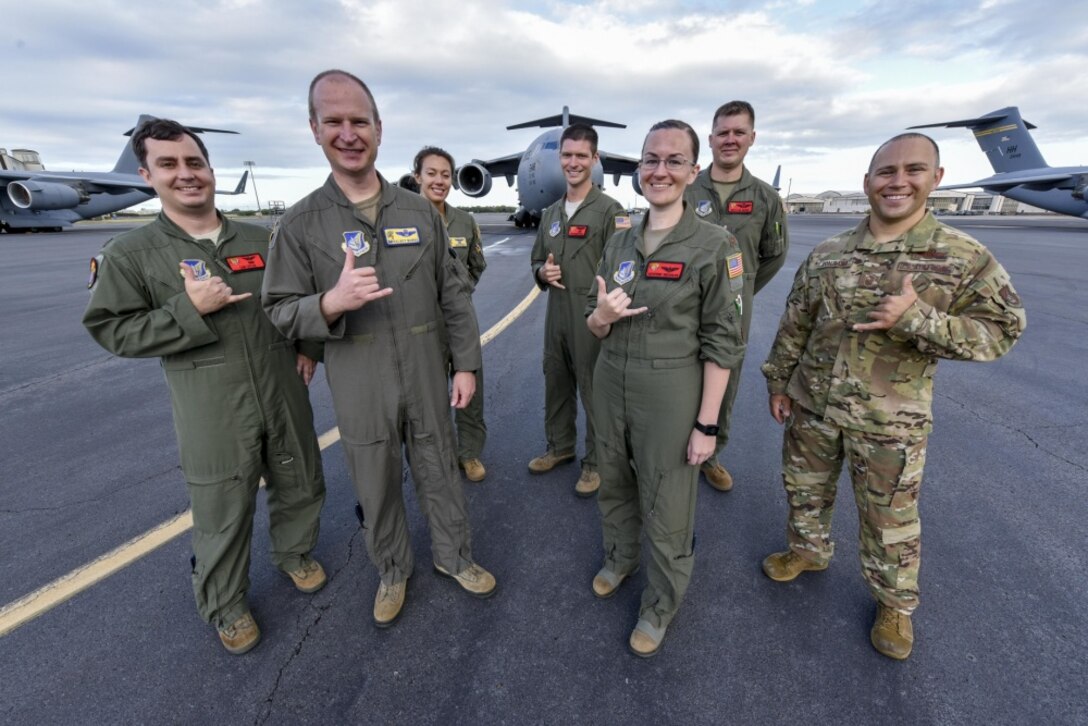 U.S. Air Force Col. W. Halsey Burks, 15th Wing commander, poses for a photo with a C-17 Globemaster III crew before his fini flight at Joint Base Pearl Harbor-Hickam, Hawaii, June 9, 2020. Burks, who served as the wing commander since June 2018, retired after 25 years of service. Tail number 5148 is the same aircraft Burks flew from the Boeing factory to Hickam Field in 2006 (U.S. Air Force photo by Tech. Sgt. Anthony Nelson Jr.)