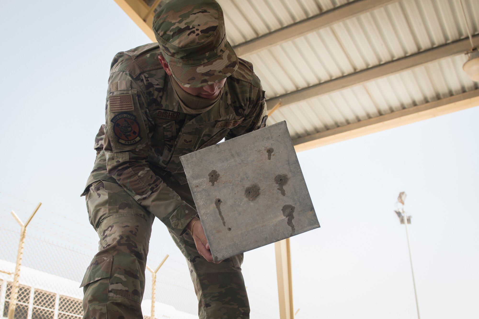 U.S. Air Force Senior Airman Ryan Disher, a vehicle operator assigned to the 379th Expeditionary Logistics Readiness Squadron, removes a drainage pan from a vehicle wash rack at Al Udeid Air Base, Qatar, June 13, 2020.