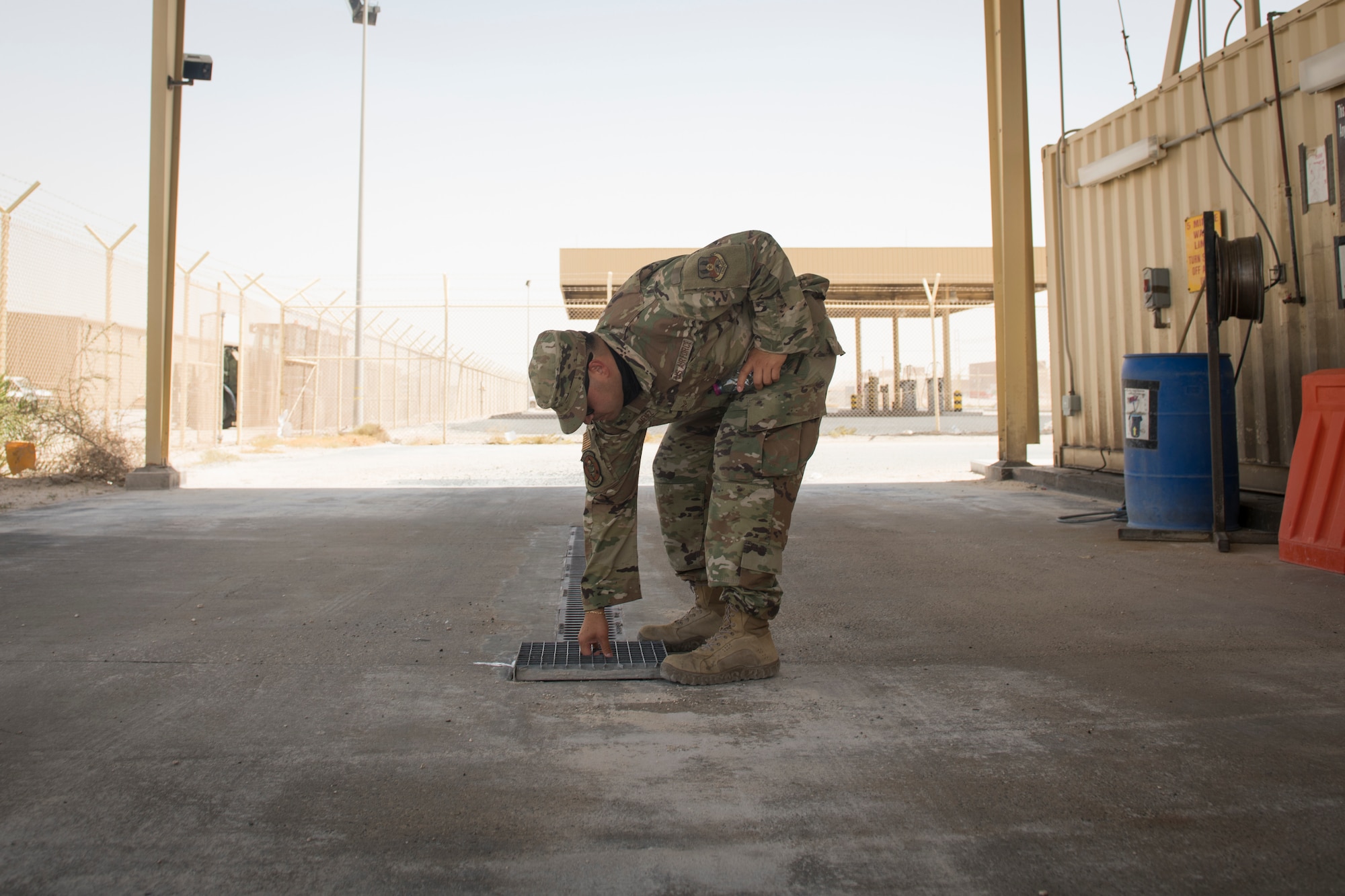 U.S. Air Force Senior Airman Fernando Jimenez, a vehicle operator assigned to the 379th Expeditionary Logistics Readiness Squadron, returns a drainage pan into a vehicle wash rack at Al Udeid Air Base, Qatar, June 13, 2020.