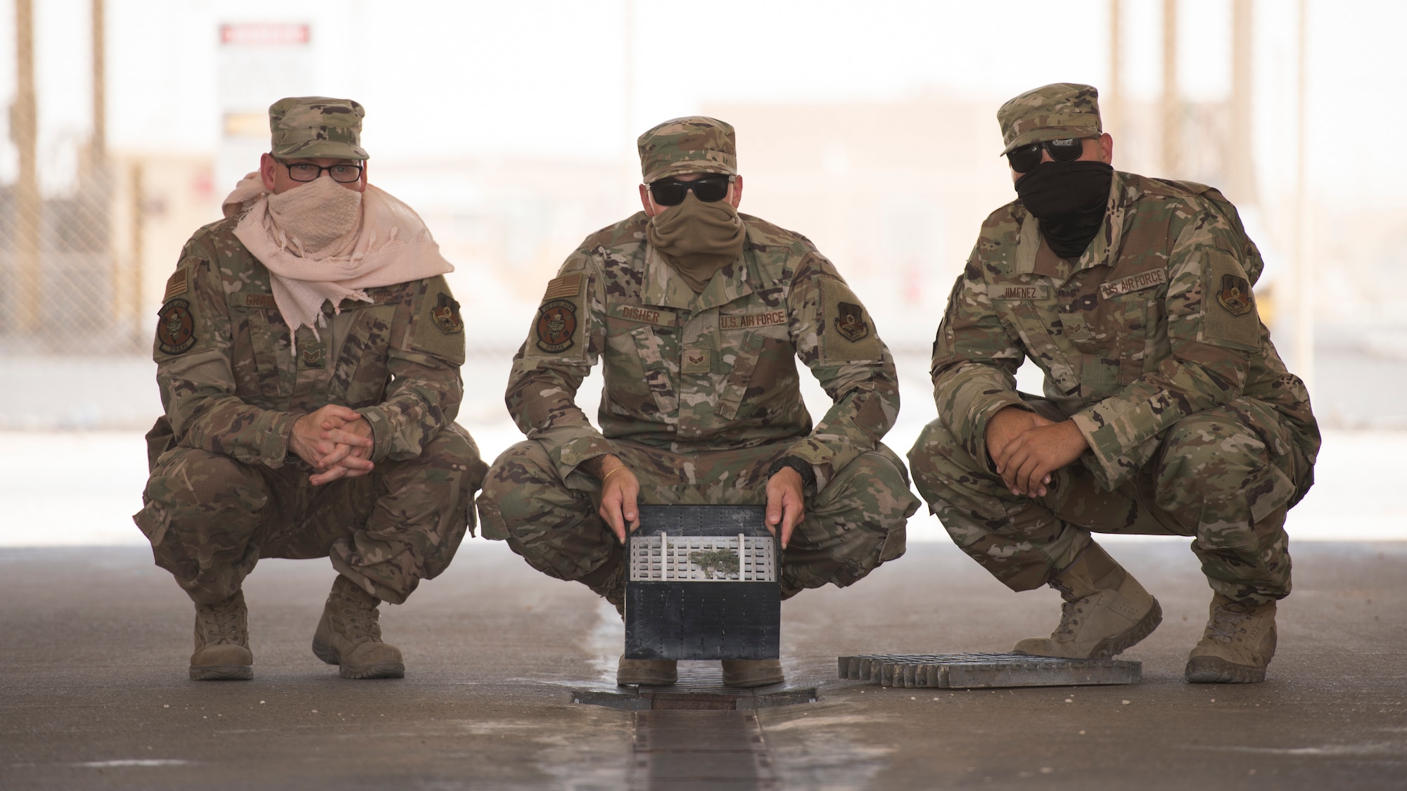 U.S. Air Force Staff Sgt. Justin Grahn, left, and U.S. Air Force Senior Airmen Ryan Disher, center, and Fernando Jimenez, vehicle operators assigned to the 379th Expeditionary Logistics Readiness Squadron, display their team’s winning submission in the U.S. Air Forces Central Command Spark Tank competition at Al Udeid Air Base, Qatar, June 13, 2020.