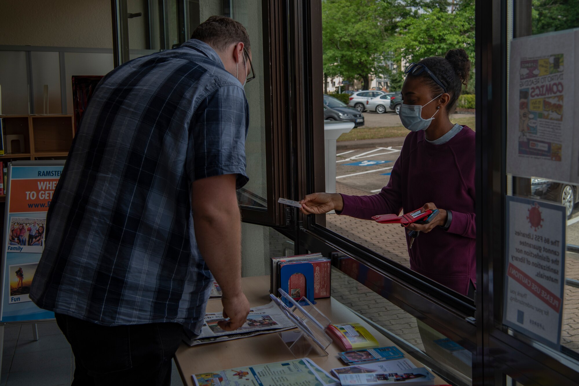 Due to COVID-19 physical distancing, staff verify customer identities in the system without having to touch their library card.