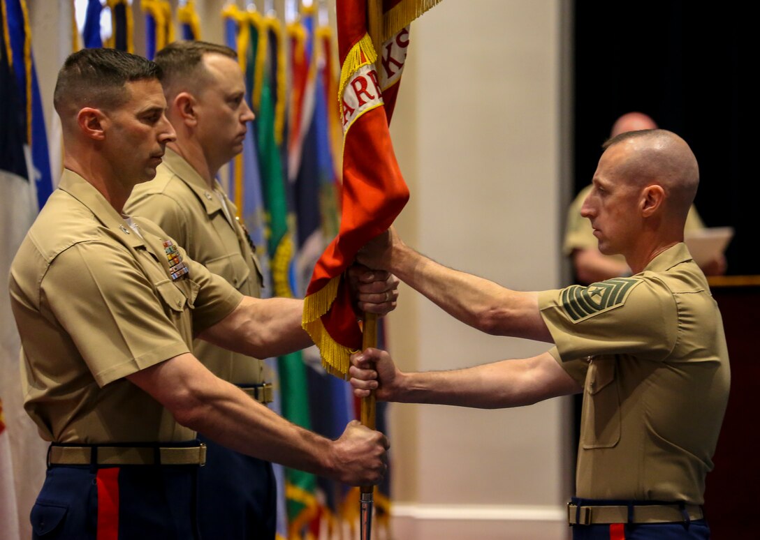 Sergeant Maj. Adrian L. Tagliere, right, battalion sergeant major, Marine Barracks Washington D.C., passes off the Marine Corps Battle Colors to Col. Donald J. Tomich, outgoing commanding officer, Marine Barracks Washington D.C., during a change of command ceremony at the Barracks, June 17, 2020. Colonel Donald J. Tomich relinquished his command of Marine Barracks Washington D.C. to Col. Teague A. Pastel. Pastel previously served as the Deputy Commandant for Information (DC I) where he served as the Director, Plans and Strategy Division.